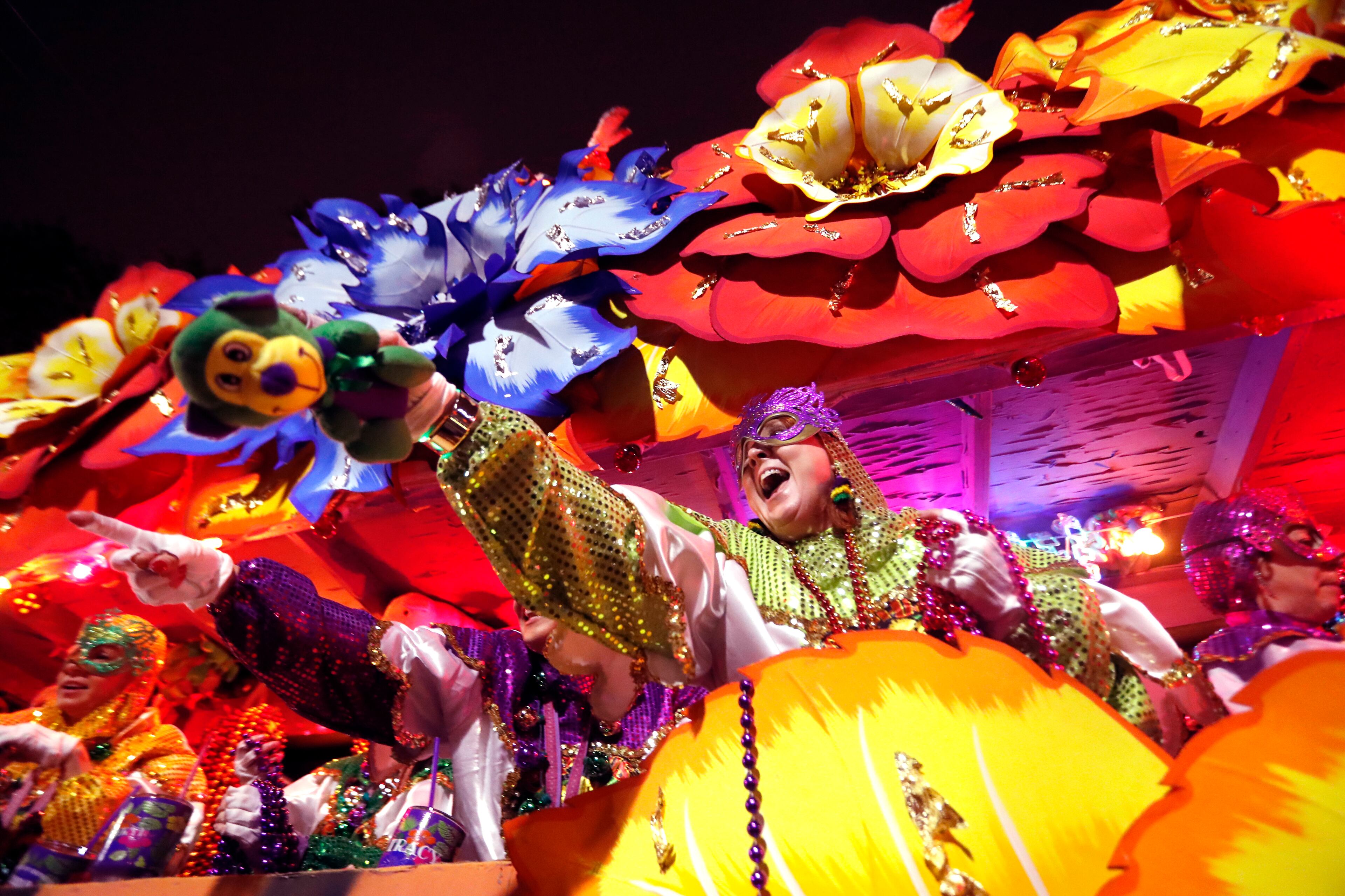 Float riders toss trinkets as the Krewe of Orpheus rolls in New Orleans, Monday, Feb. 12, 2018. (AP Photo/Gerald Herbert)