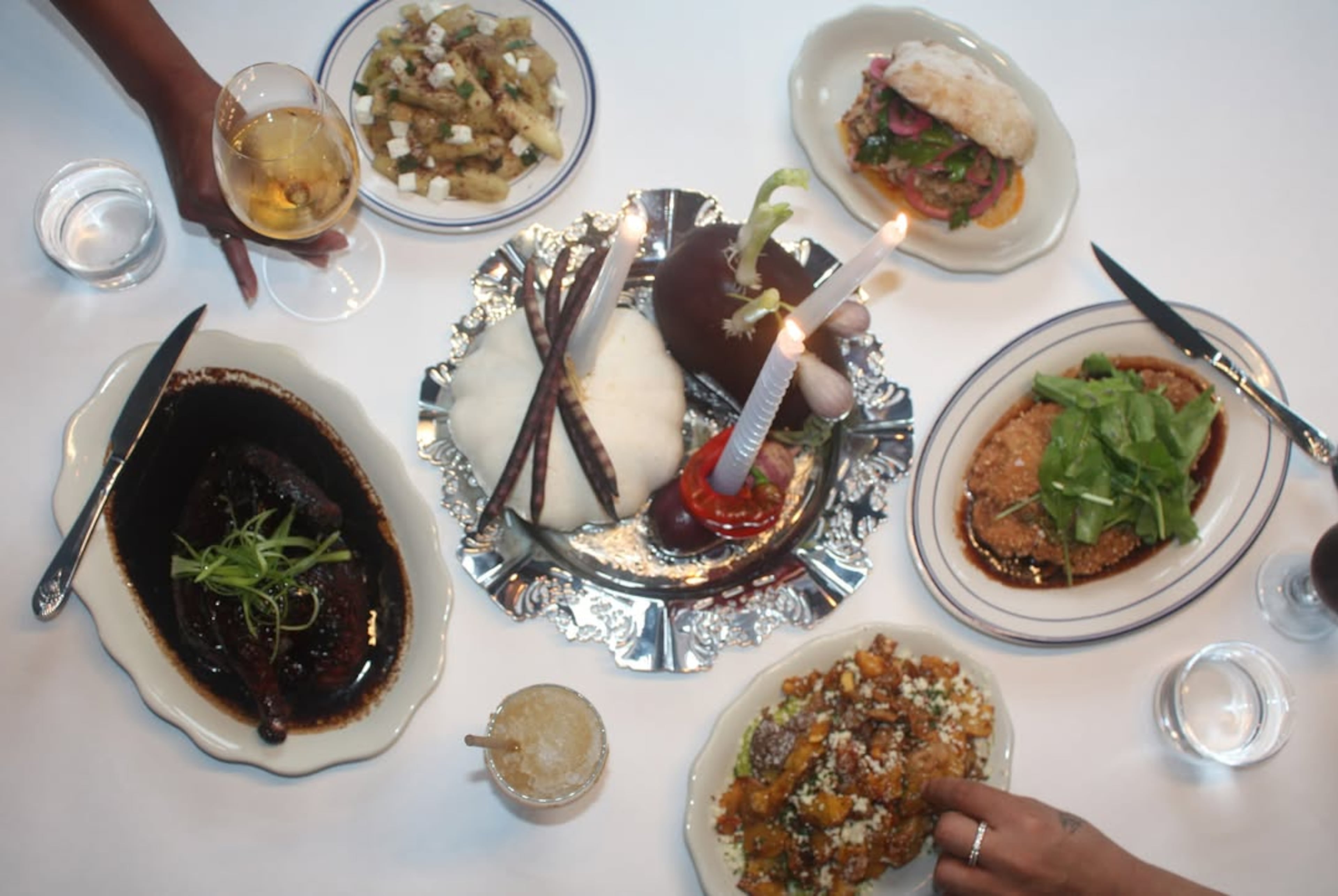 The food at Last Dance draws from a variety of different global cuisines, like the half chicken with gyoza sauce (bottom left). (Courtesy of Kathryn Fitzgerald/Last Dance)