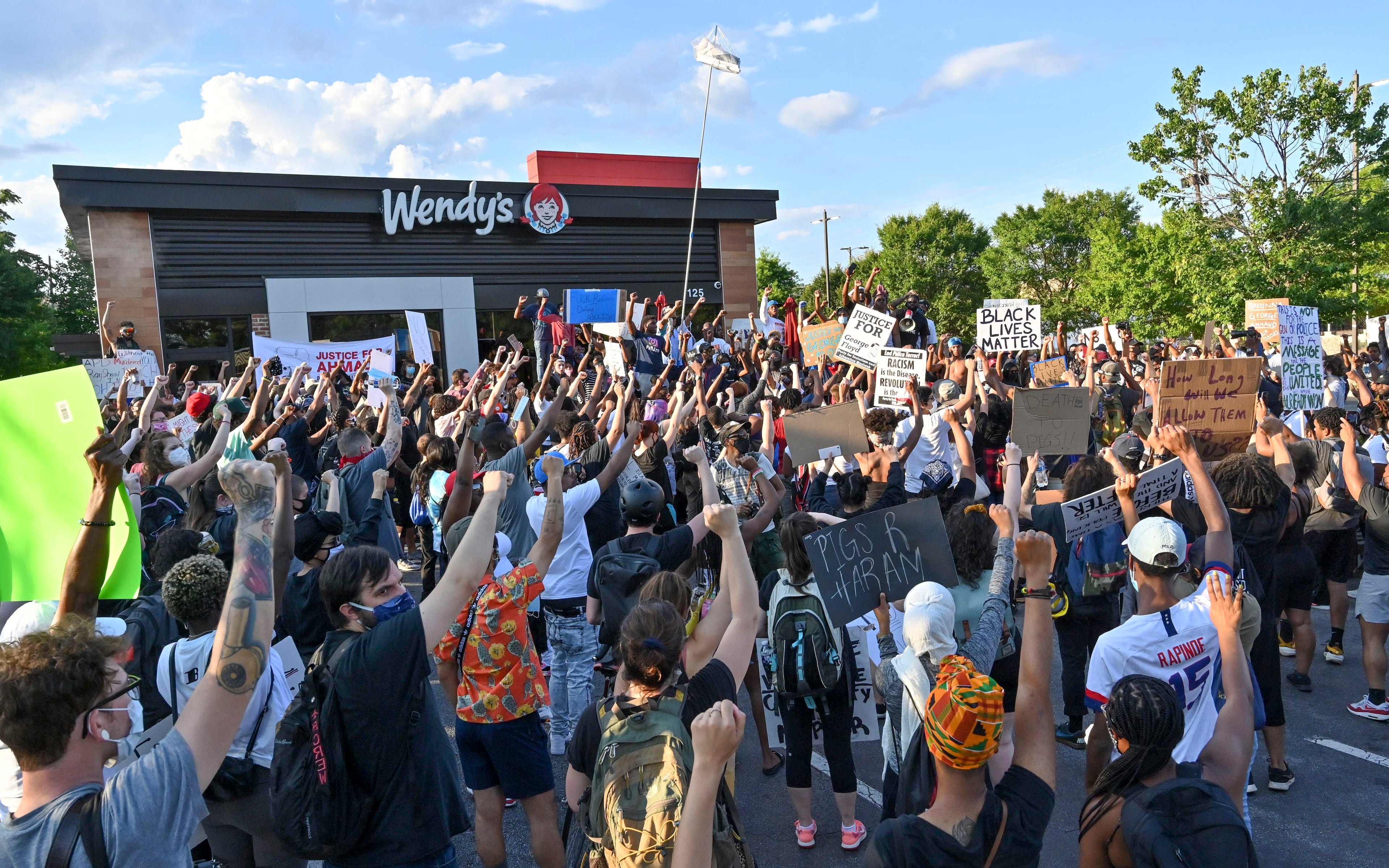 Protesters gather on Saturday, June 13, 2020, at the Atlanta Wendy's where Rayshard Brooks, a 27-year-old black man, was shot and killed by Atlanta police on Friday evening during a struggle in a Wendy's drive-thru line. Hyosub Shin / hyosub.shin@ajc.com