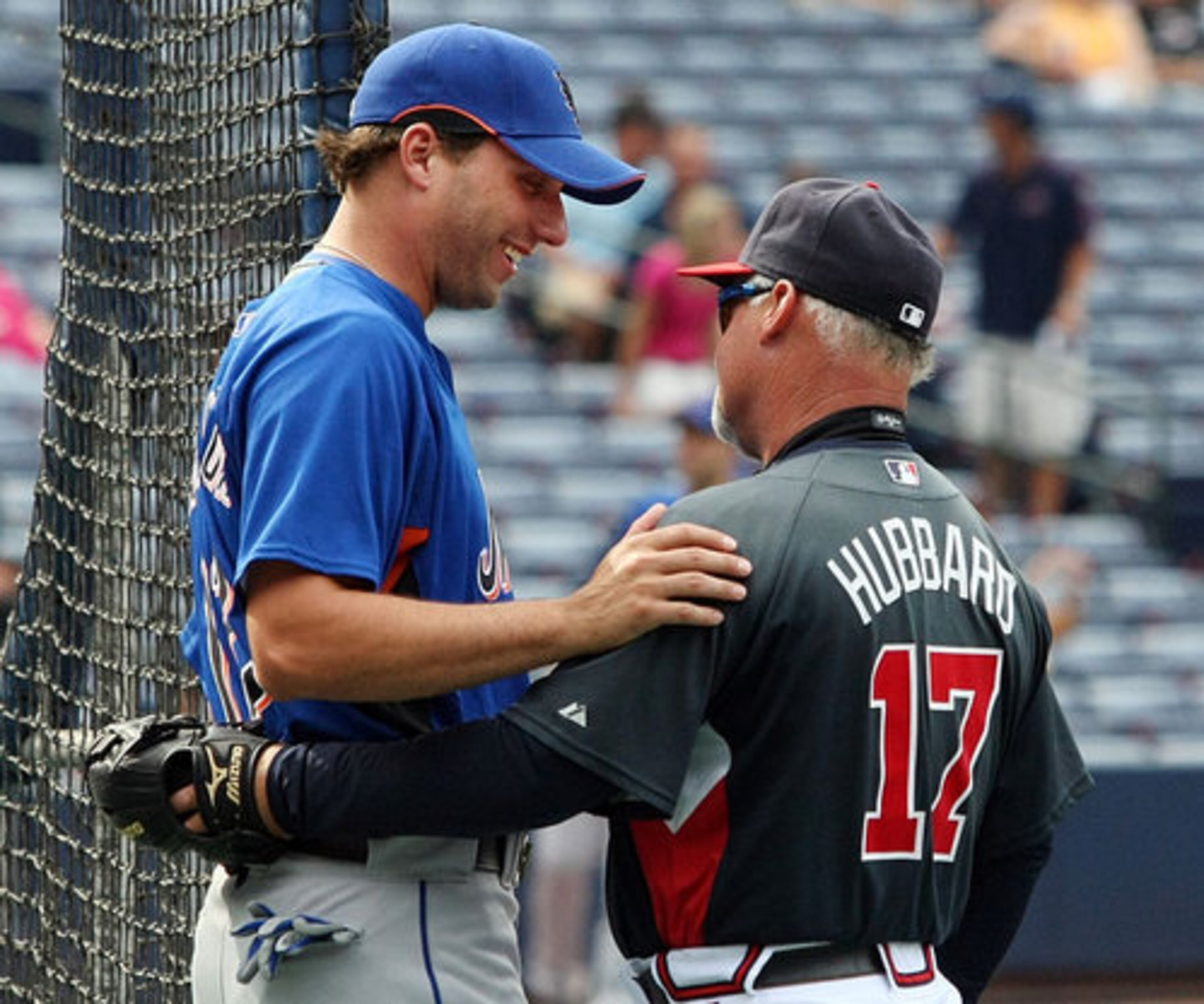 Braves first base coach Glenn Hubbard talks with Francoeur.