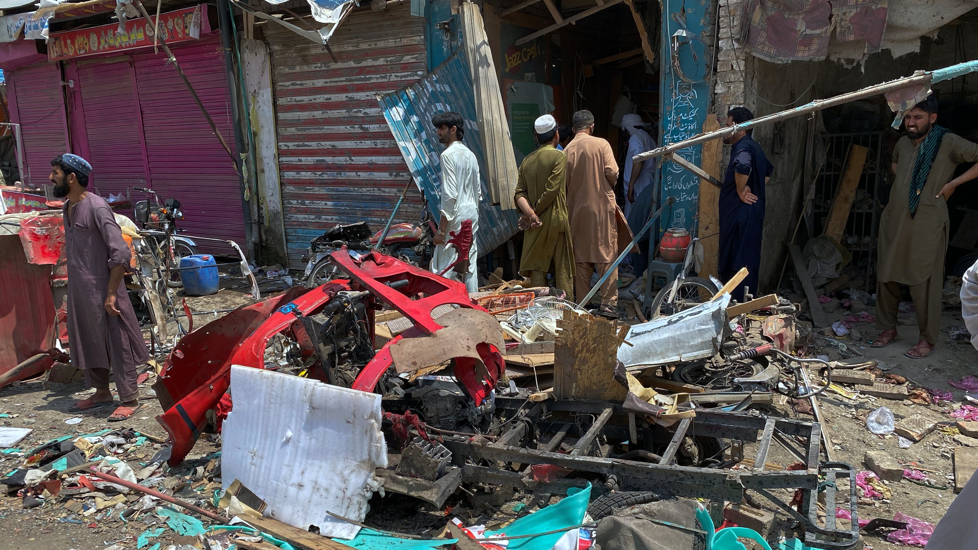 Local residents examine damage at the site of a bomb explosion at a market in Sarai Norag in Lakki Marwat, a district in Pakistan's Khyber Pakhtunkhwa province, Tuesday, May 12, 2026. (AP Photo/Farhat Ullah)