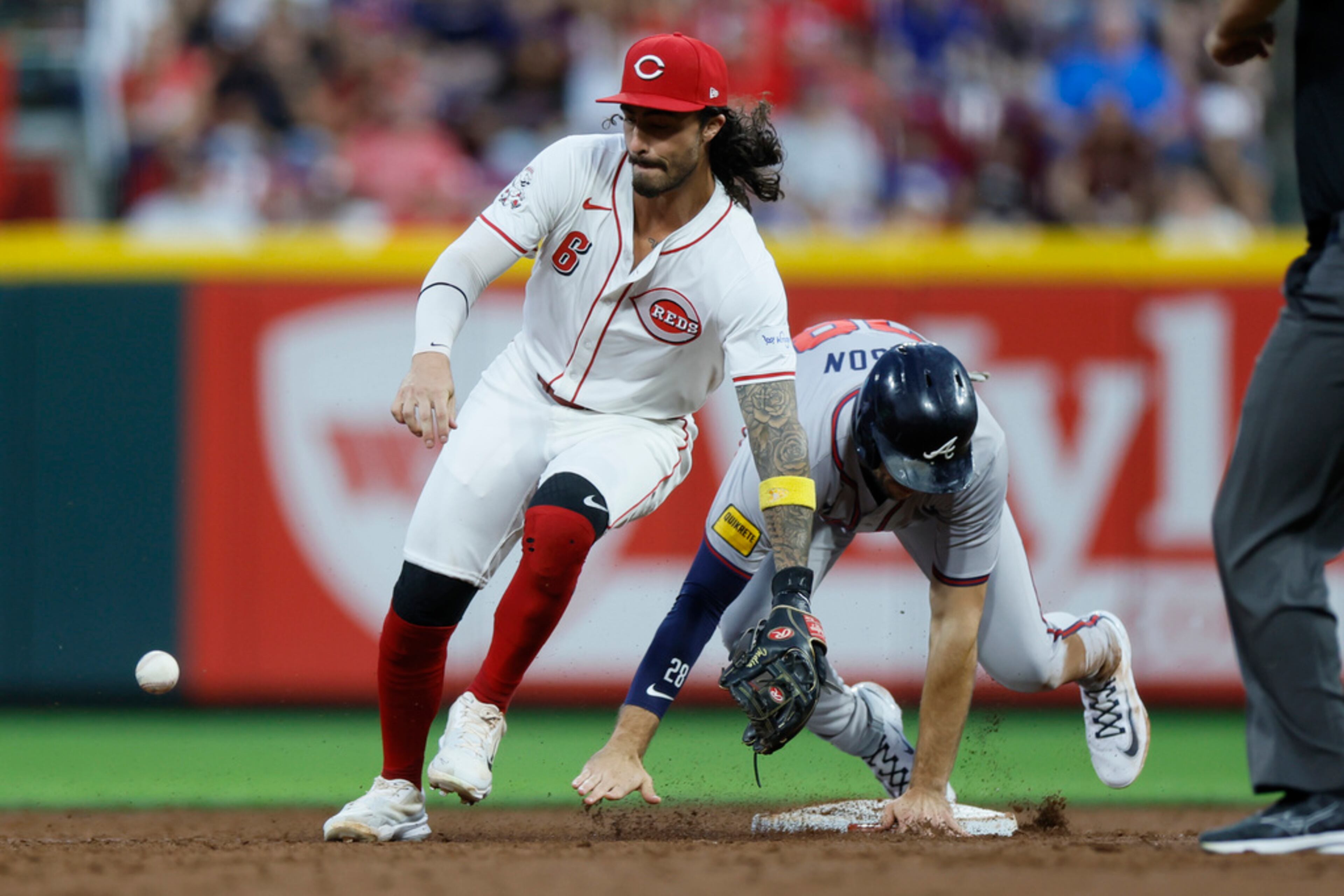 Cincinnati Reds second baseman Jonathan India, left, tries to control the ball as Atlanta Braves' Matt Olson slides safely into second base on a ball hit by Atlanta Braves' Ramon Laureano during the second inning of a baseball game Tuesday, Sept. 17, 2024, in Cincinnati. (AP Photo/Jay LaPrete)