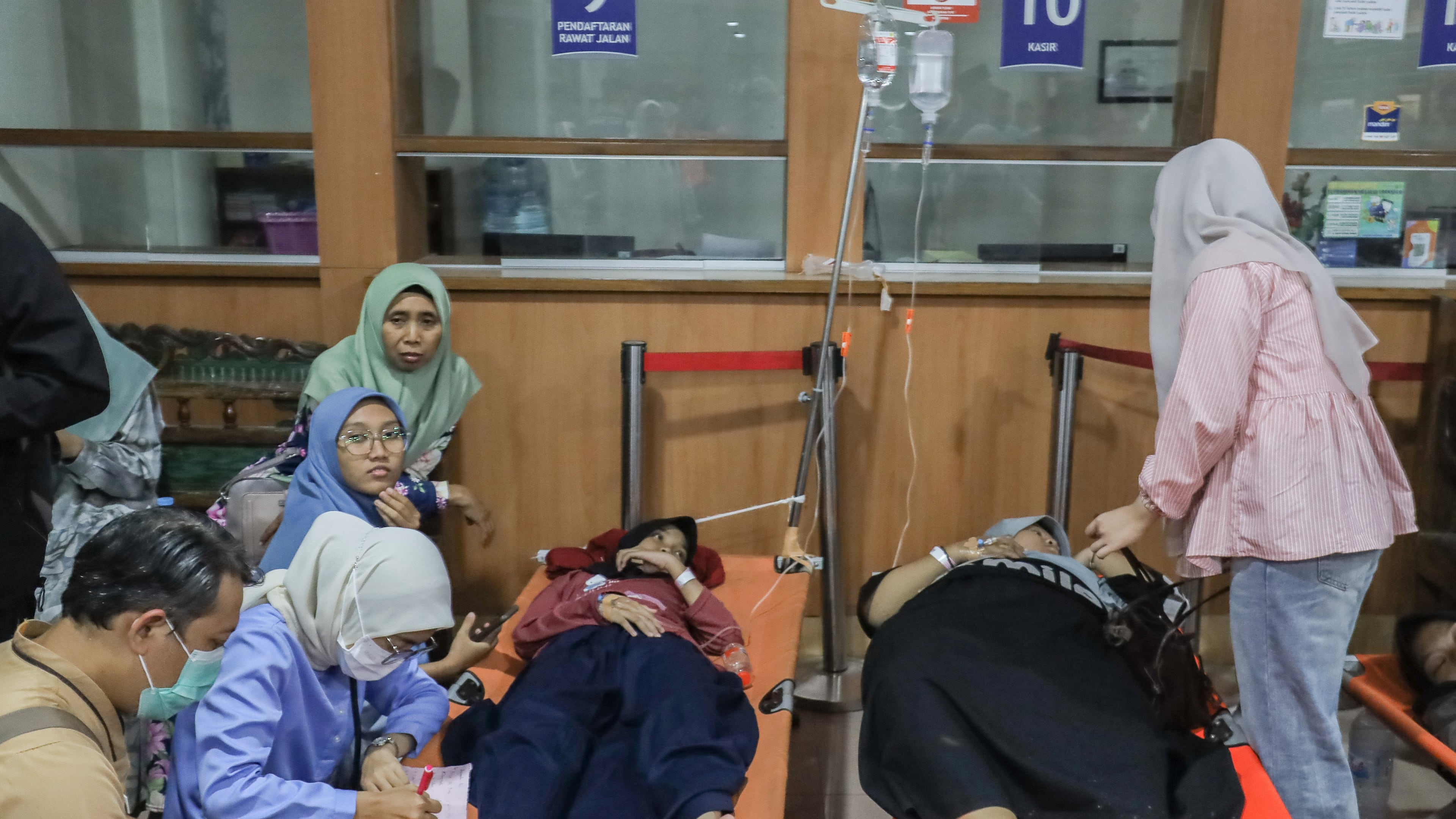Students who fell ill allegedly due to food poisoning after consuming free meals at their school receive medical treatment at a hospital in Sidoarjo, East Java, Indonesia, Wednesday, Sept. 2, 2026. (AP Photo/Jusuf Aydin)