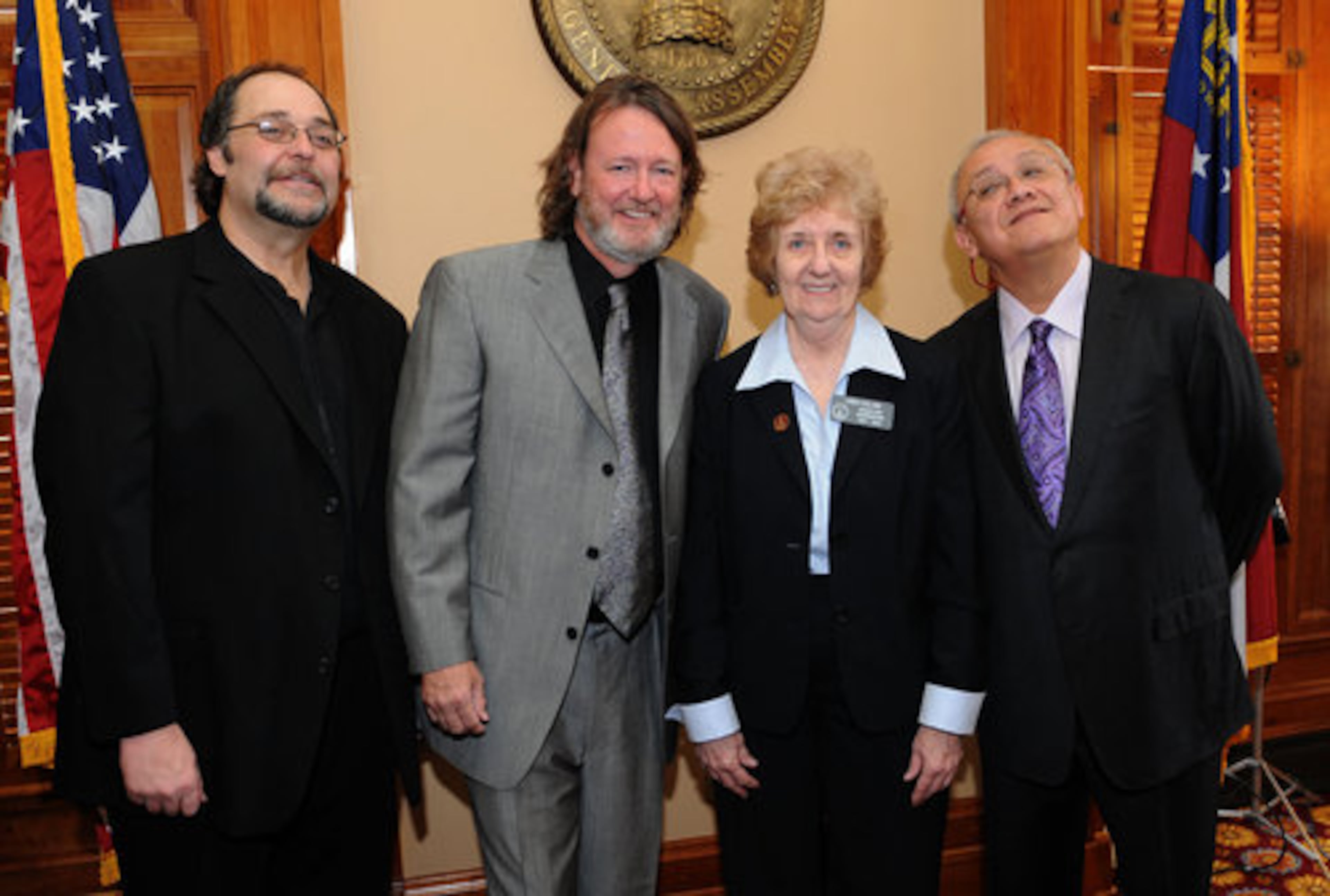 Widespread Panic's Todd Nance, John Bell and Domingo Ortiz pose with Linda Collins, Assistant Doorkeeper for the Georgia House of Representatives, on Tuesday, Feb 15, 2011.