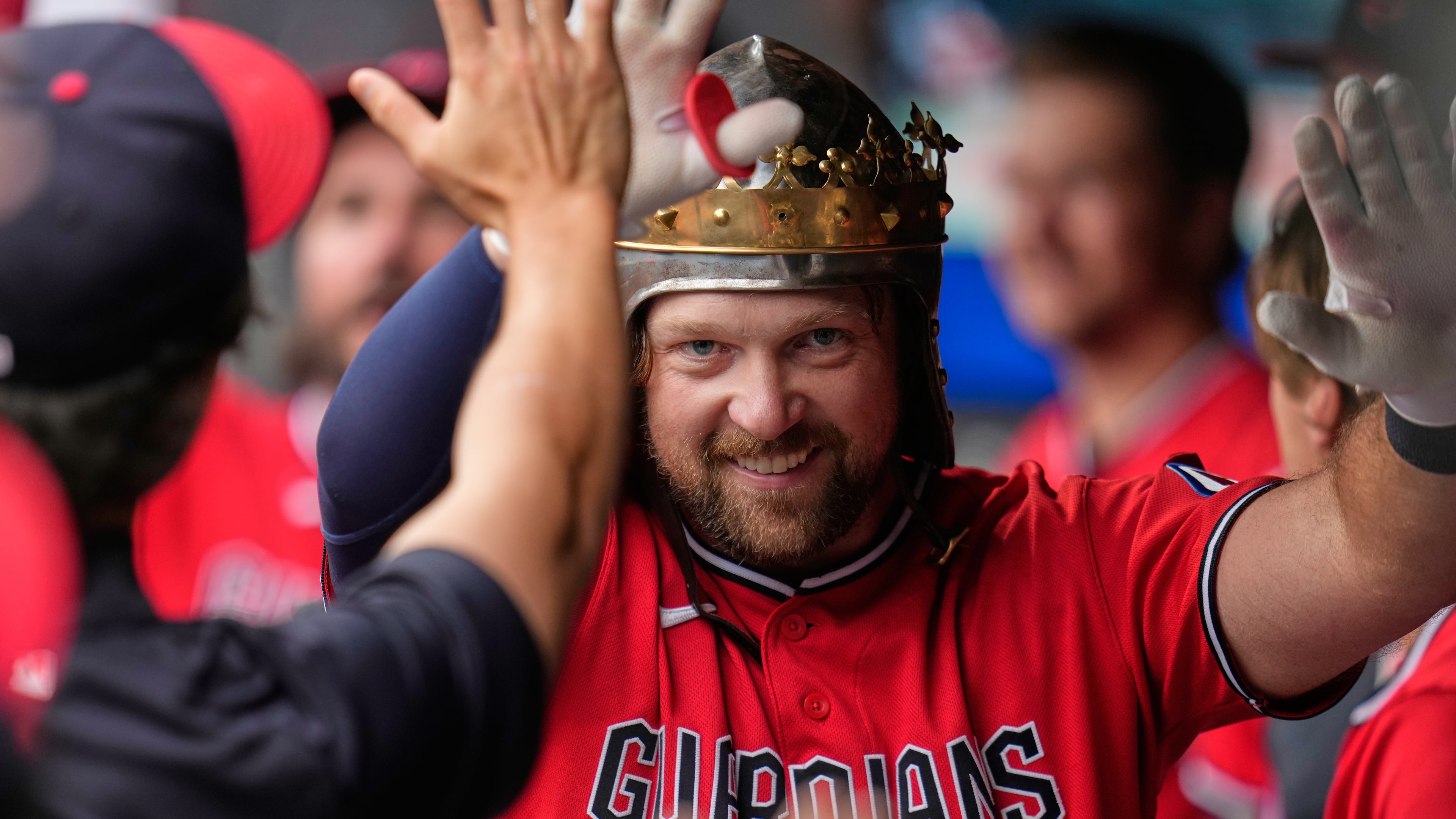 Cleveland Guardians' Rhys Hoskins celebrates in the dugout after hitting a home run in the first inning of a baseball game against the Minnesota Twins in Cleveland, Monday, July 20, 2026. (AP Photo/Sue Ogrocki)