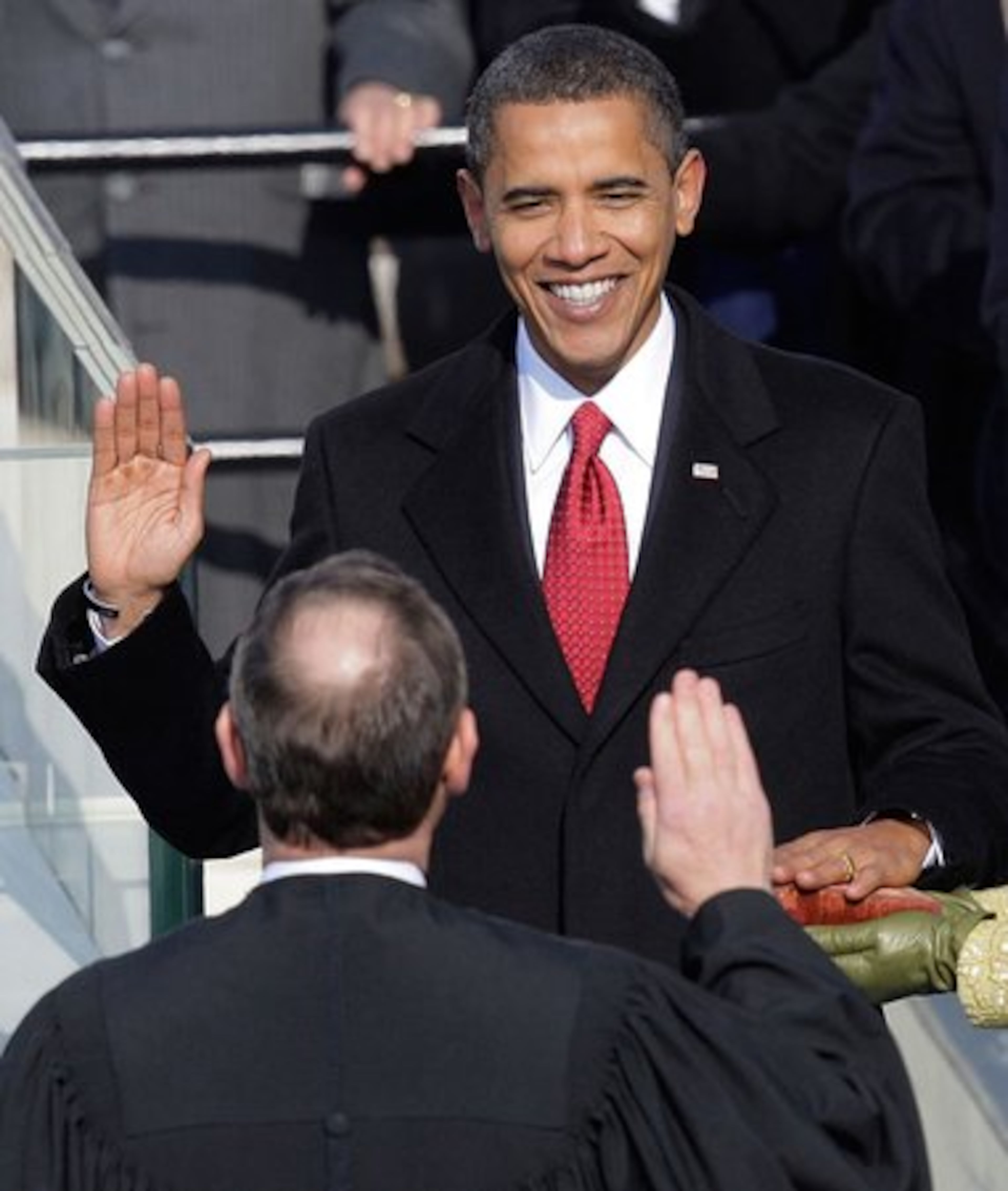 Barack Obama takes the oath of office from Chief Justice John Roberts to become the 44th president of the United States. Follow Obama's historic day in this photo gallery.