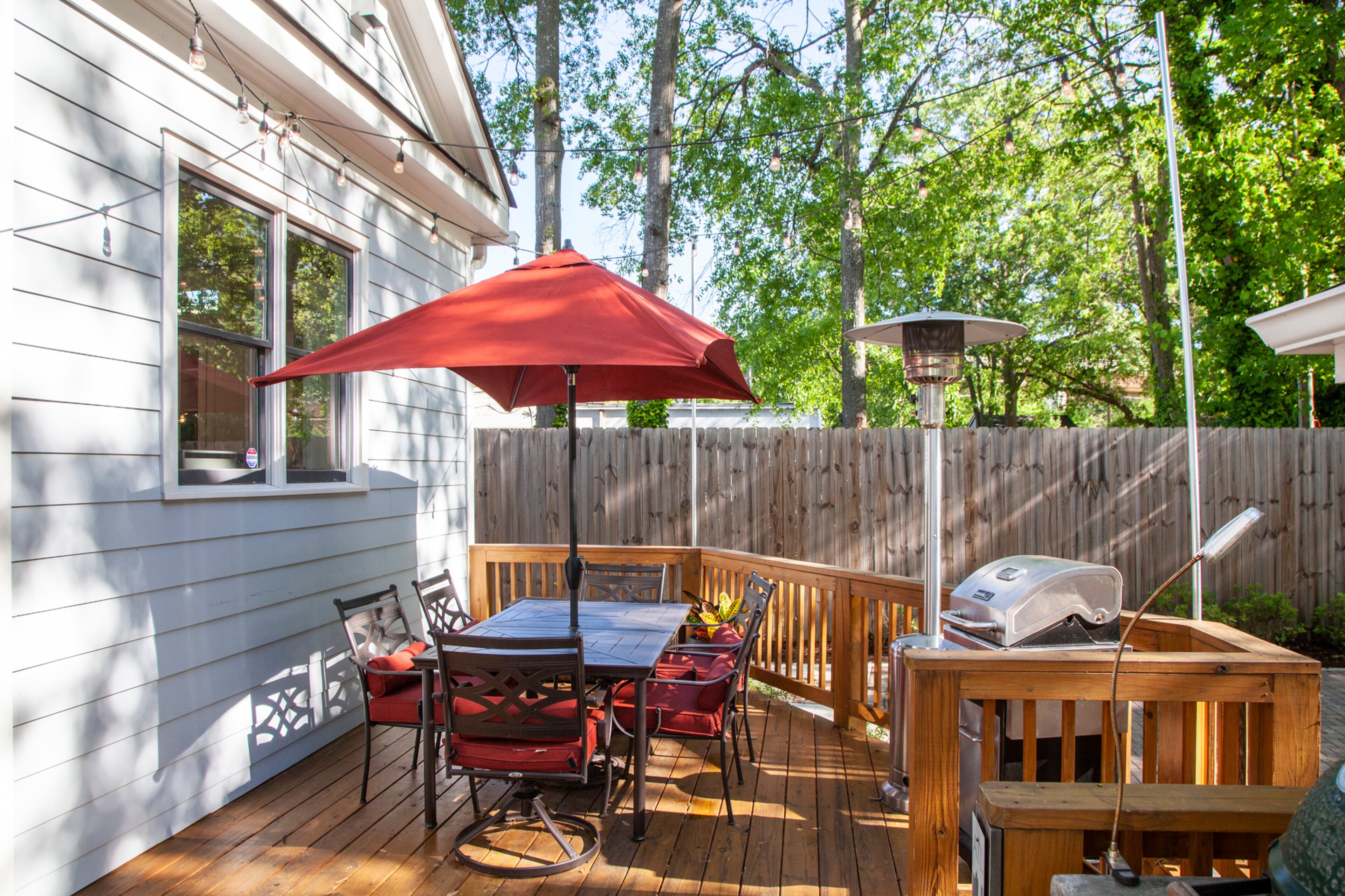 Off the kitchen, the back deck is furnished with a Hampton Bay patio set from The Home Depot.