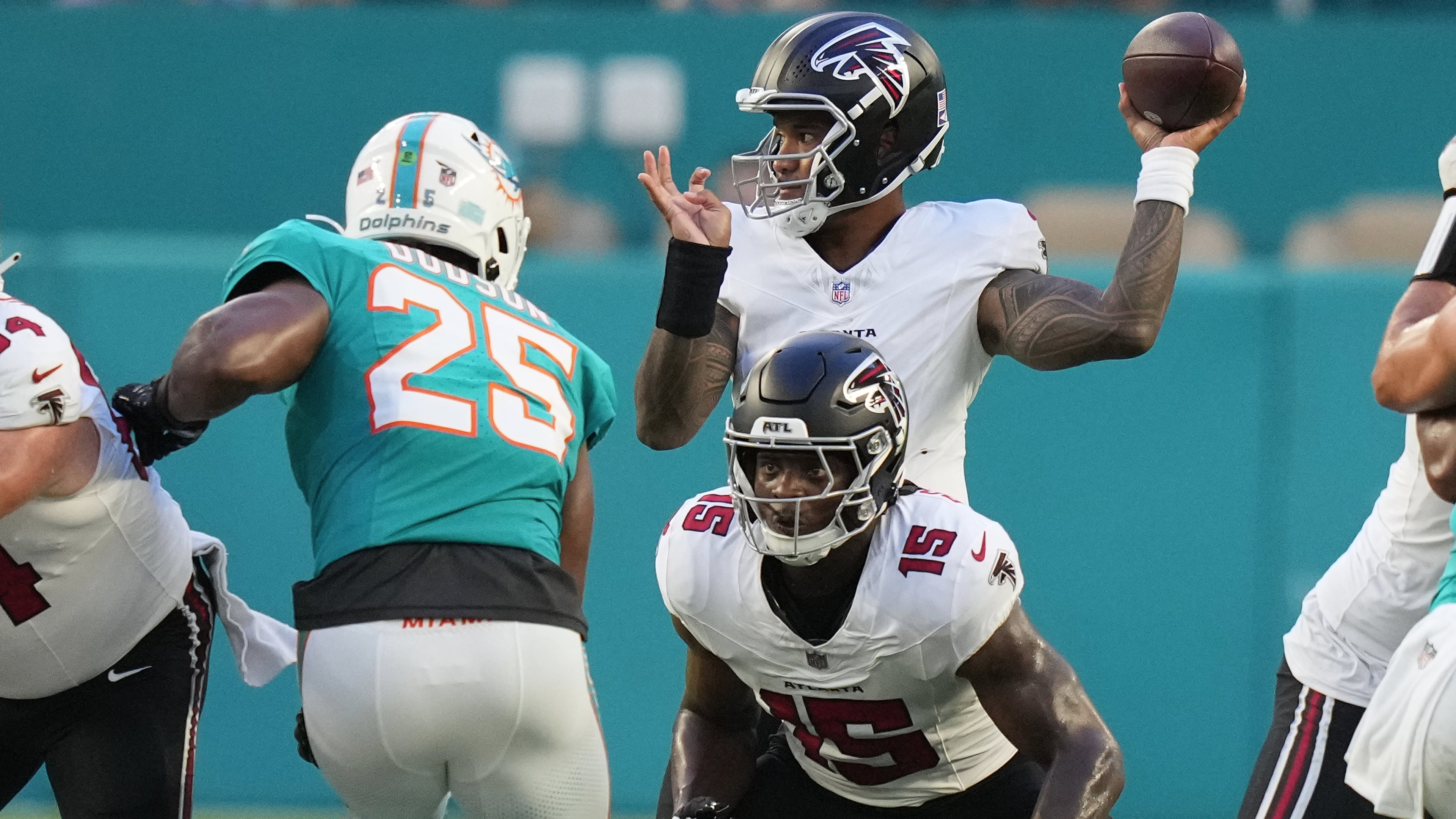 Falcons quarterback Tua Tagovailoa (back) looks to throw as running back Brian Robinson Jr. readies to block Dolphins linebacker Tyrel Dodson during their NFL exhibition game on Friday, Aug. 28, 2026, in Miami Gardens, Fla. (Lynne Sladky/AP)