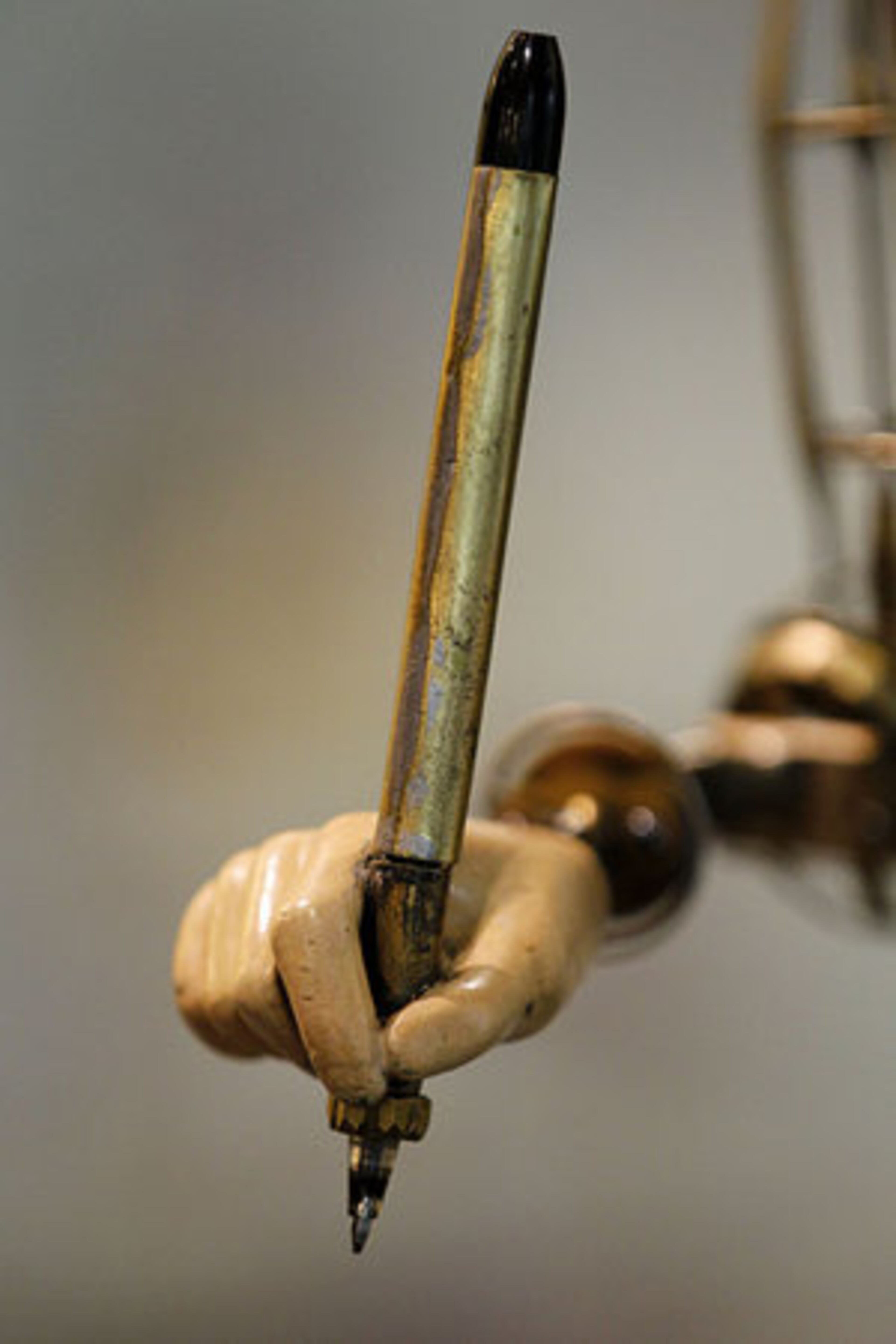 This close up shows the hand and pen of the approximately 210-year-old automaton. The mechanized doll can write three poems and draw four pictures