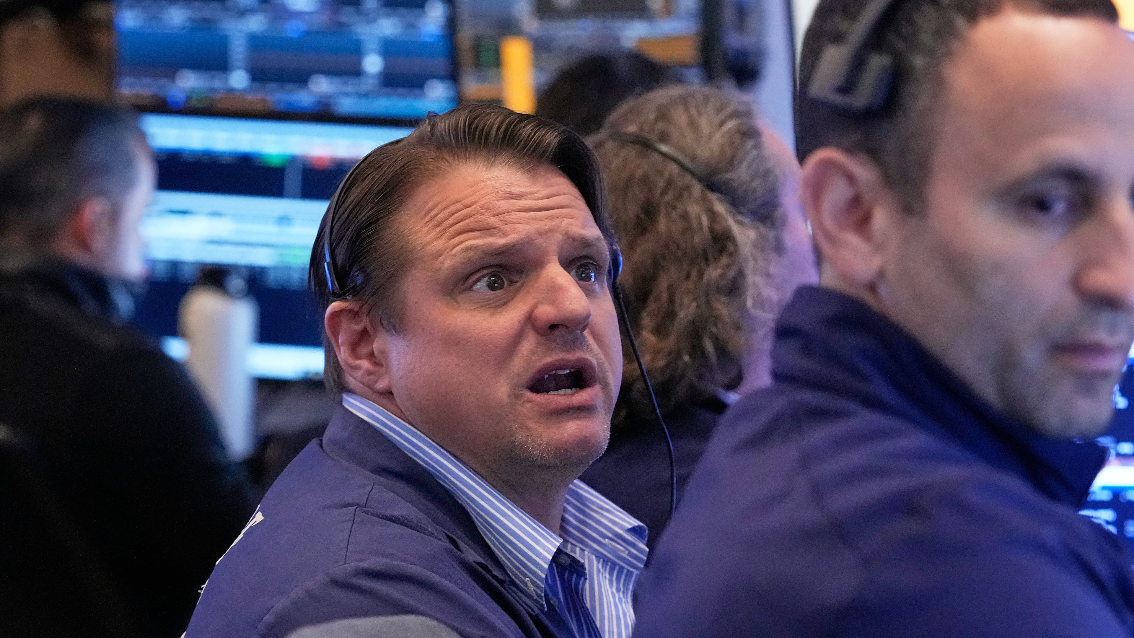 Trader Michael Milano, left, works on the floor of the New York Stock Exchange, Monday, April 20, 2026. (AP Photo/Richard Drew)