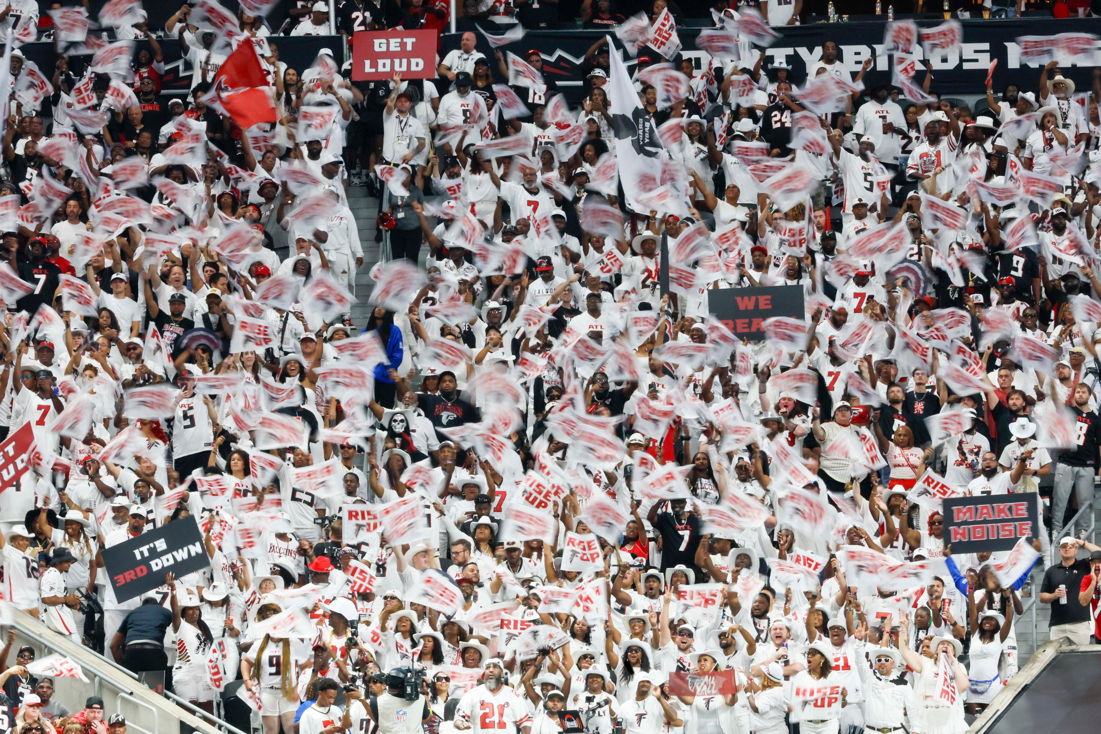 Atlanta Falcons fans wave flags after their team scores a touchdown during the first half of an NFL football game against the Tampa Bay Buccaneers at Mercedes-Benz Stadium on Sunday, September 7, 2025, in Atlanta.
(Miguel Martinez/ AJC)