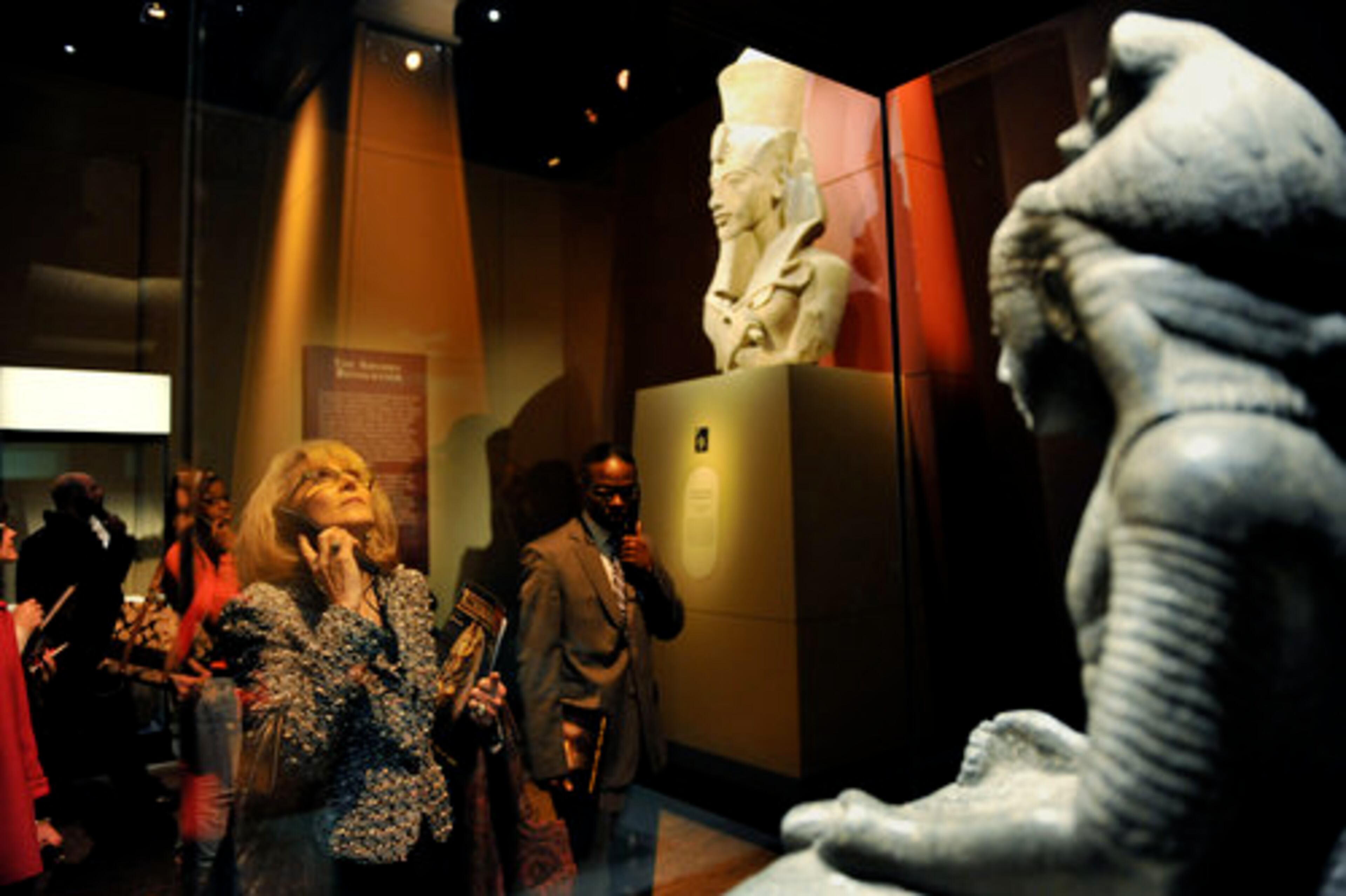 Anita Thomas, a board member with Emory's Michael C. Carlos Museum, takes the audio tour through the exhibit.