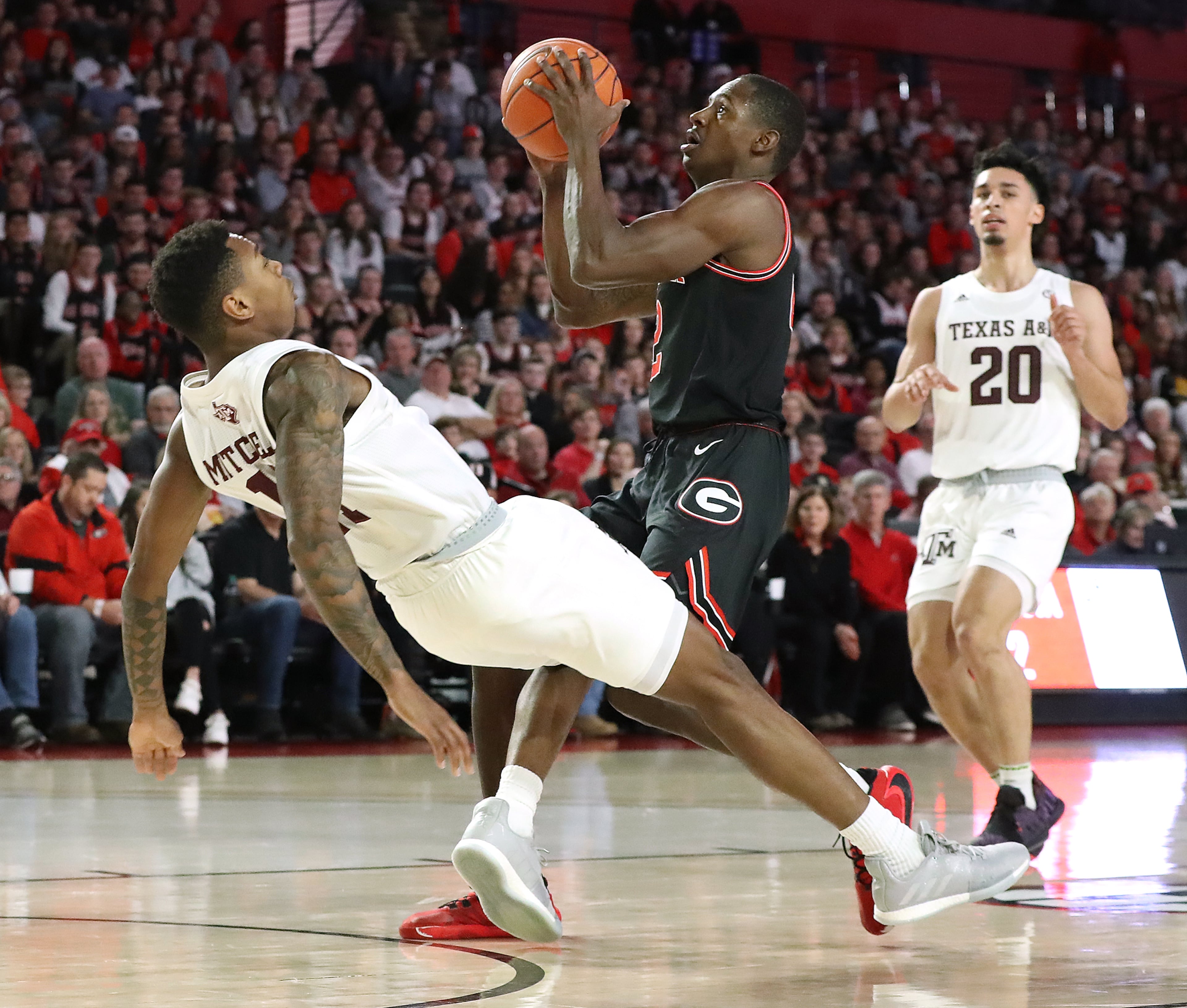 Georgia guard Jordan Harris is called for an offensive foul knocking Texas A&M guard Wendell Mitchell to the hardwood during the first half in a NCAA college basketball game on Saturday, Feb. 1, 2020, in Athens. Curtis Compton ccompton@ajc.com