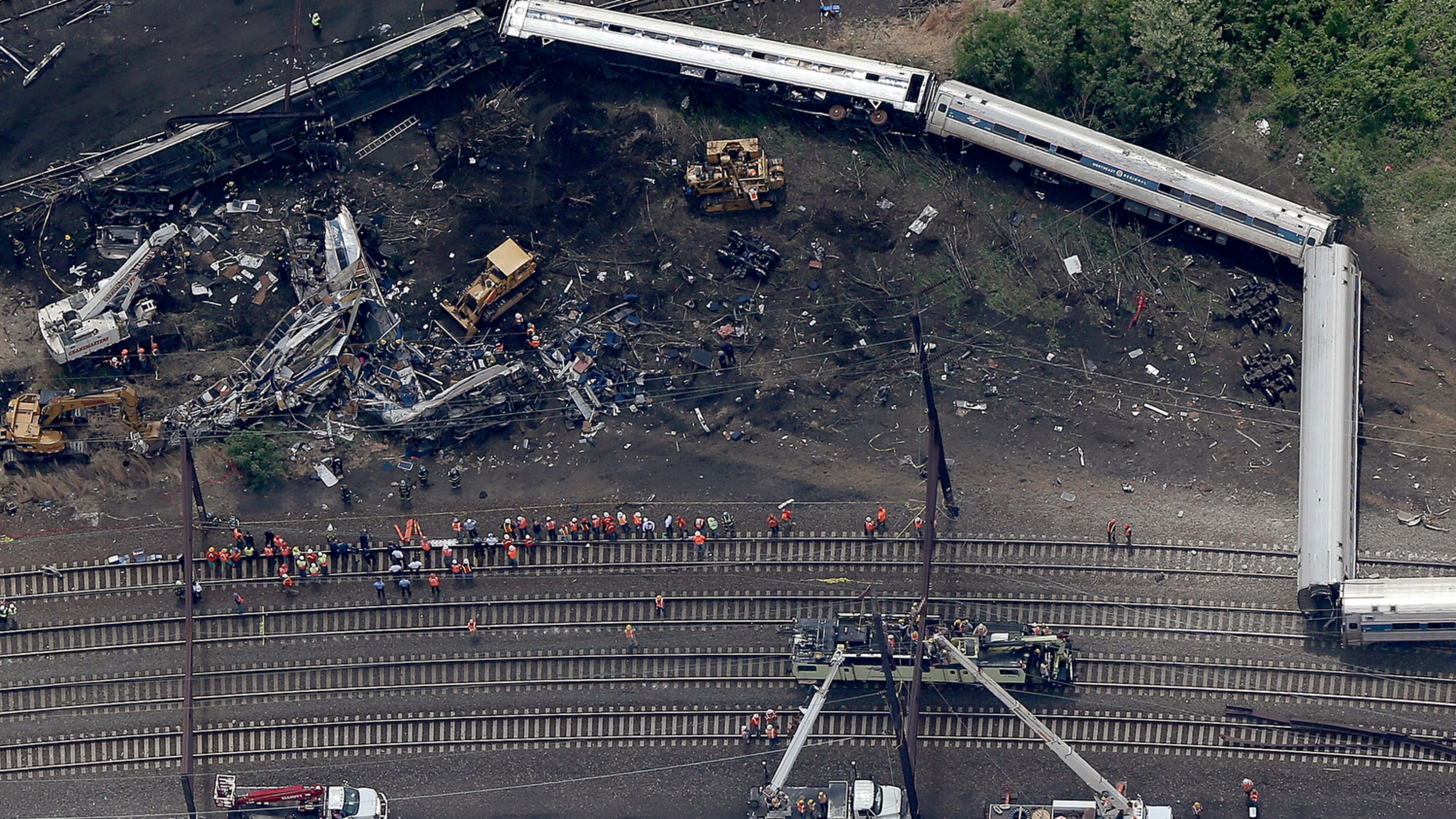 FATAL TRAIN DERAILMENT--PHILADELPHIA, PA - MAY 13: Investigators and first responders work near the wreckage of Amtrak Northeast Regional Train 188, from Washington to New York, that derailed yesterday May 13, 2015 in north Philadelphia, Pennsylvania. At least six people were killed and more than 200 others were injured in the crash. (Photo by Win McNamee/Getty Images)