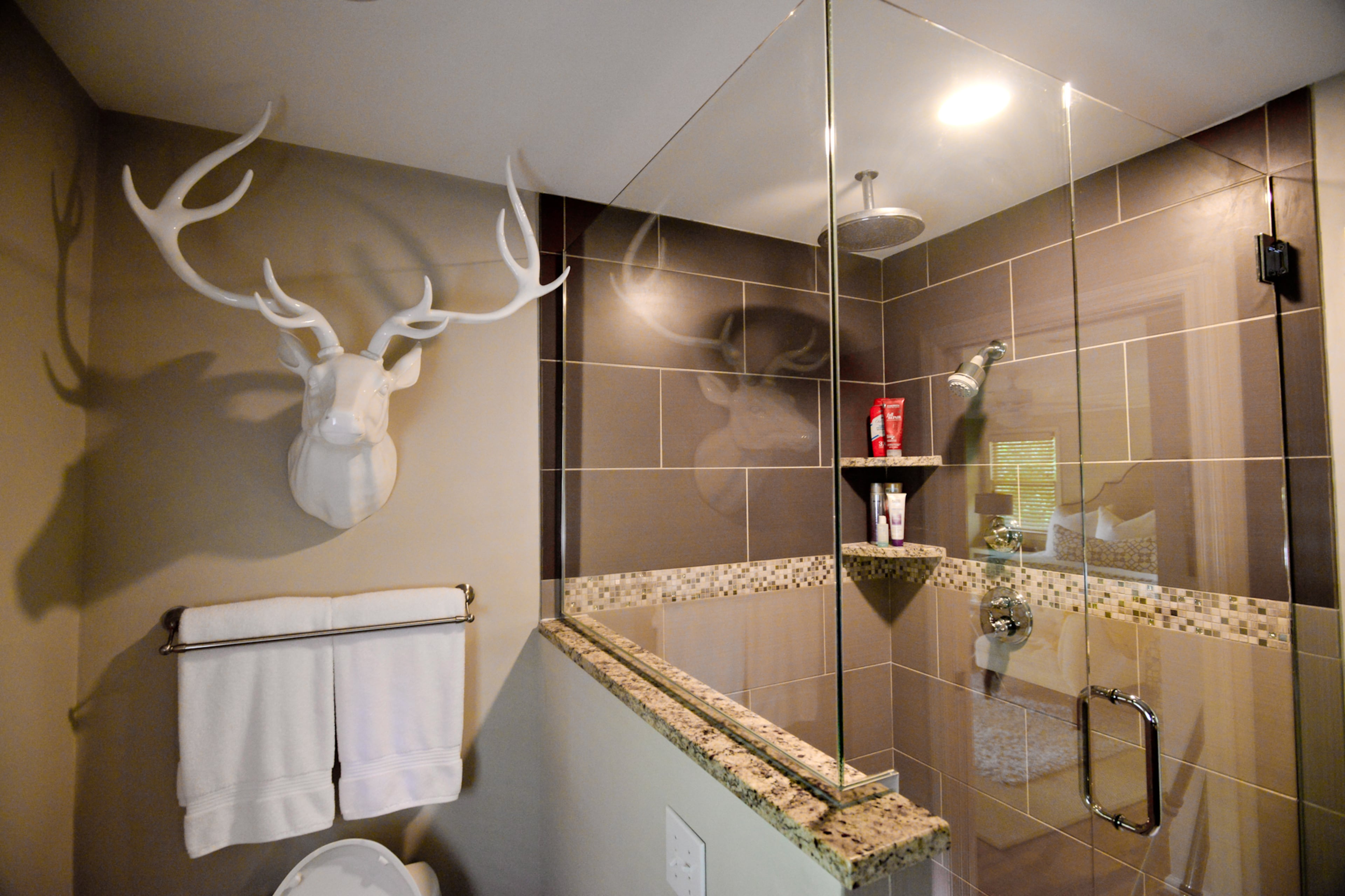 The couple updated the master bathroom, adding porcelain tile on the floor and in the shower. The wall of the shower also was changed, to build out the glass frame between the shower and the toilet. For cost savings, the couple was able to keep the vanity - which they faux painted - and a mirror, but added more modern sinks, granite countertops and new hardware.