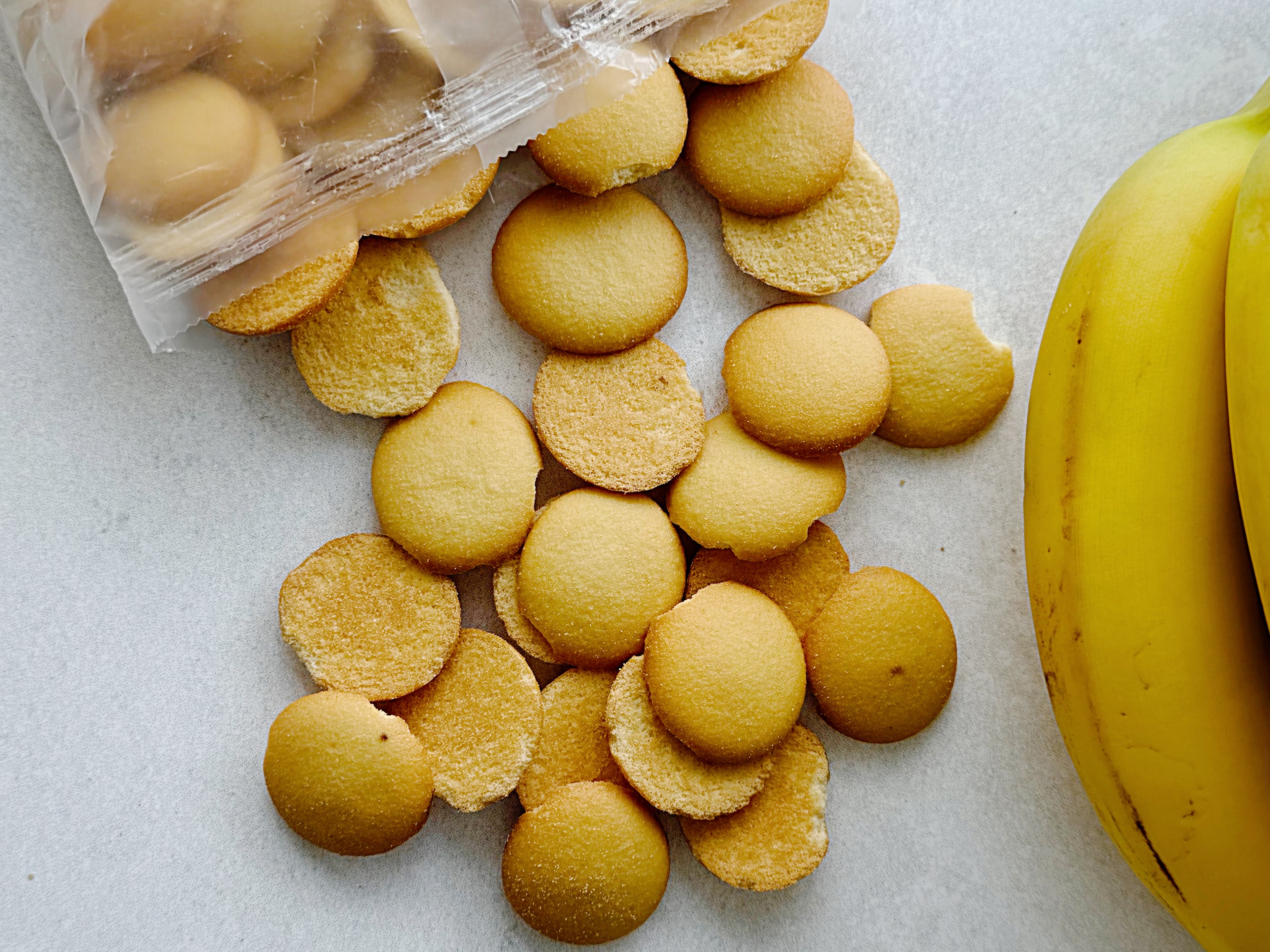 Vanilla wafers soften as banana pudding chills, absorbing moisture from the custard, and developing the tender cake-like texture characteristic of the Southern dessert.