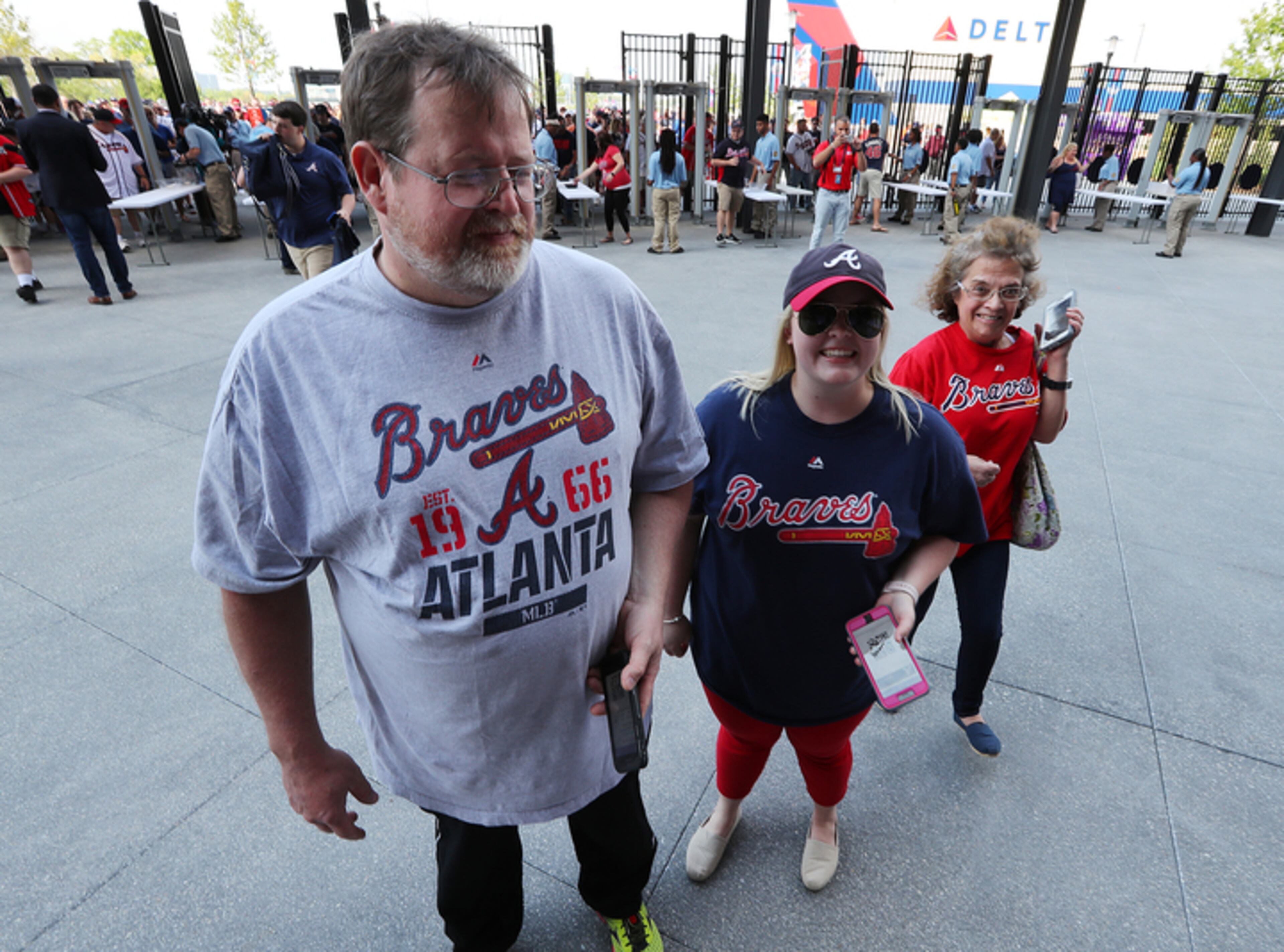 Shelby Spain, center, with mom and dad Jimmy and Ruthie, left Nashville at 7 AM Friday to be the first fans to enter SunTrust Park on Friday night for the Braves' home opener. AJC photo: Curtis Compton