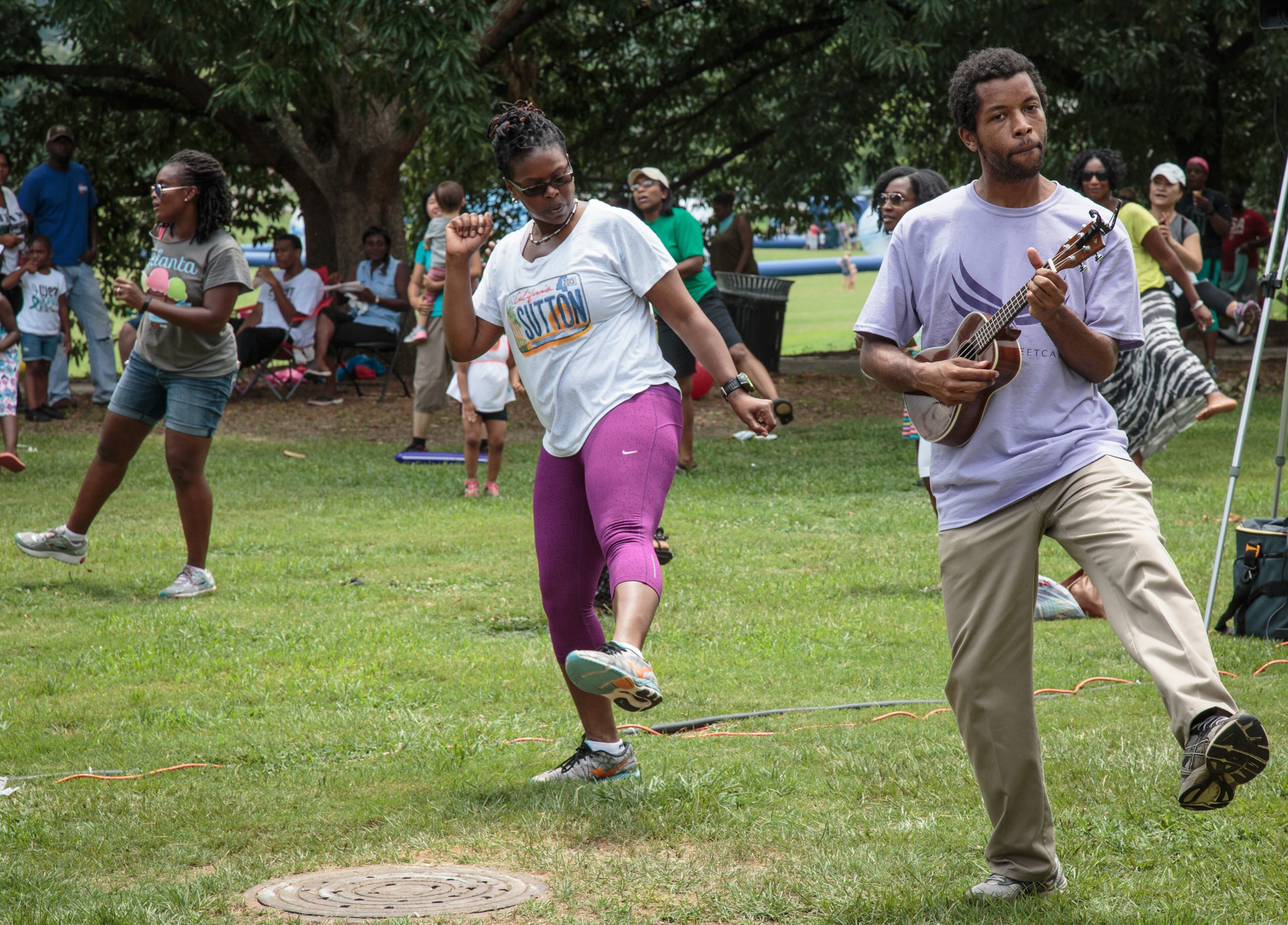 Jason Williams (R) takes part in an aerobic dance activity at the Ice Cream Festival in Piedmont Park Saturday, July 23 2016. The festival included a variety of health and fitness activities, along with an assortment of ice cream vendors. STEVE SCHAEFER / SPECIAL TO THE AJC