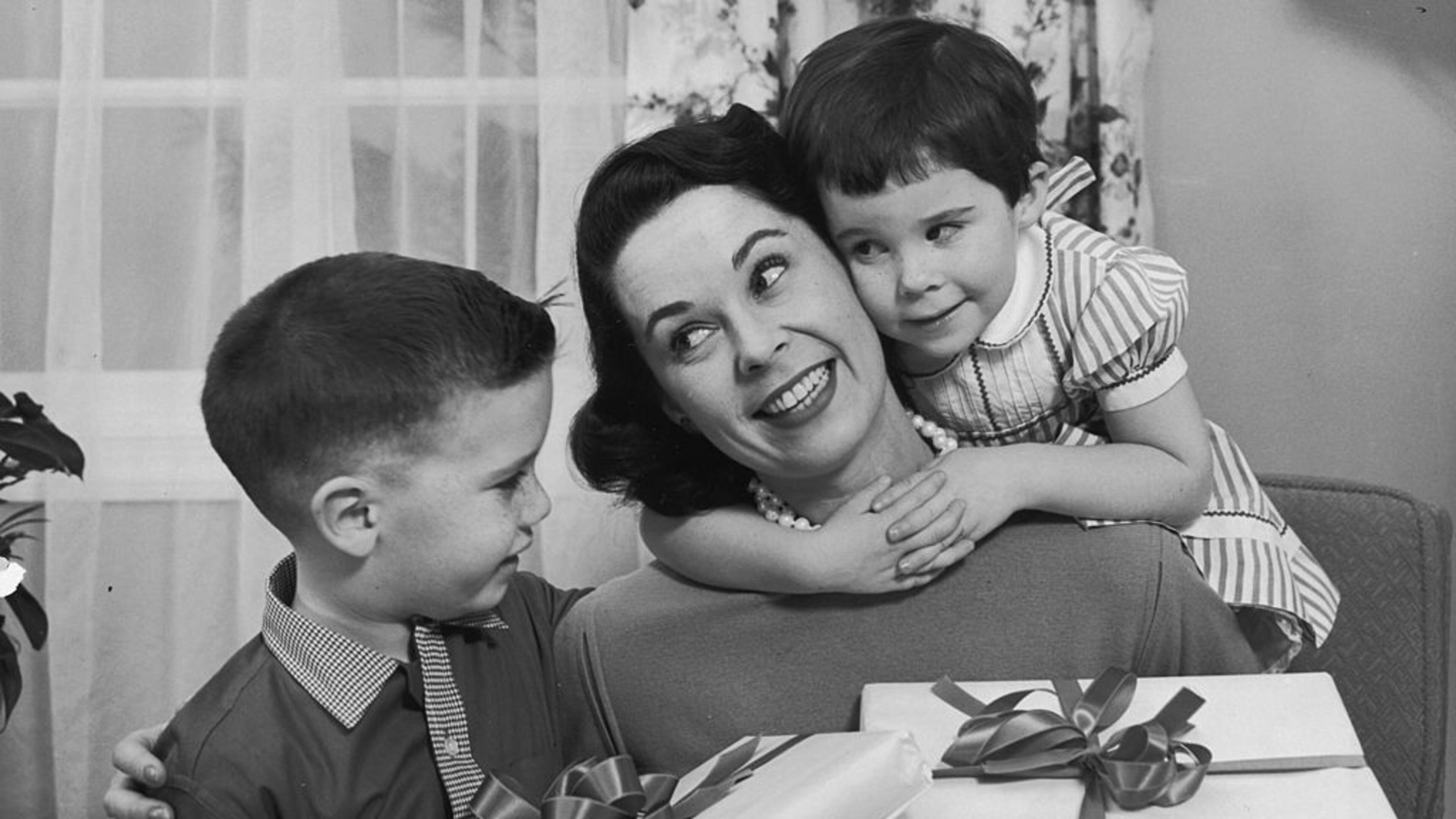 A boy and girl give presents to their mother on Mother's Day, circa 1955. (Photo by Lambert/Getty Images)