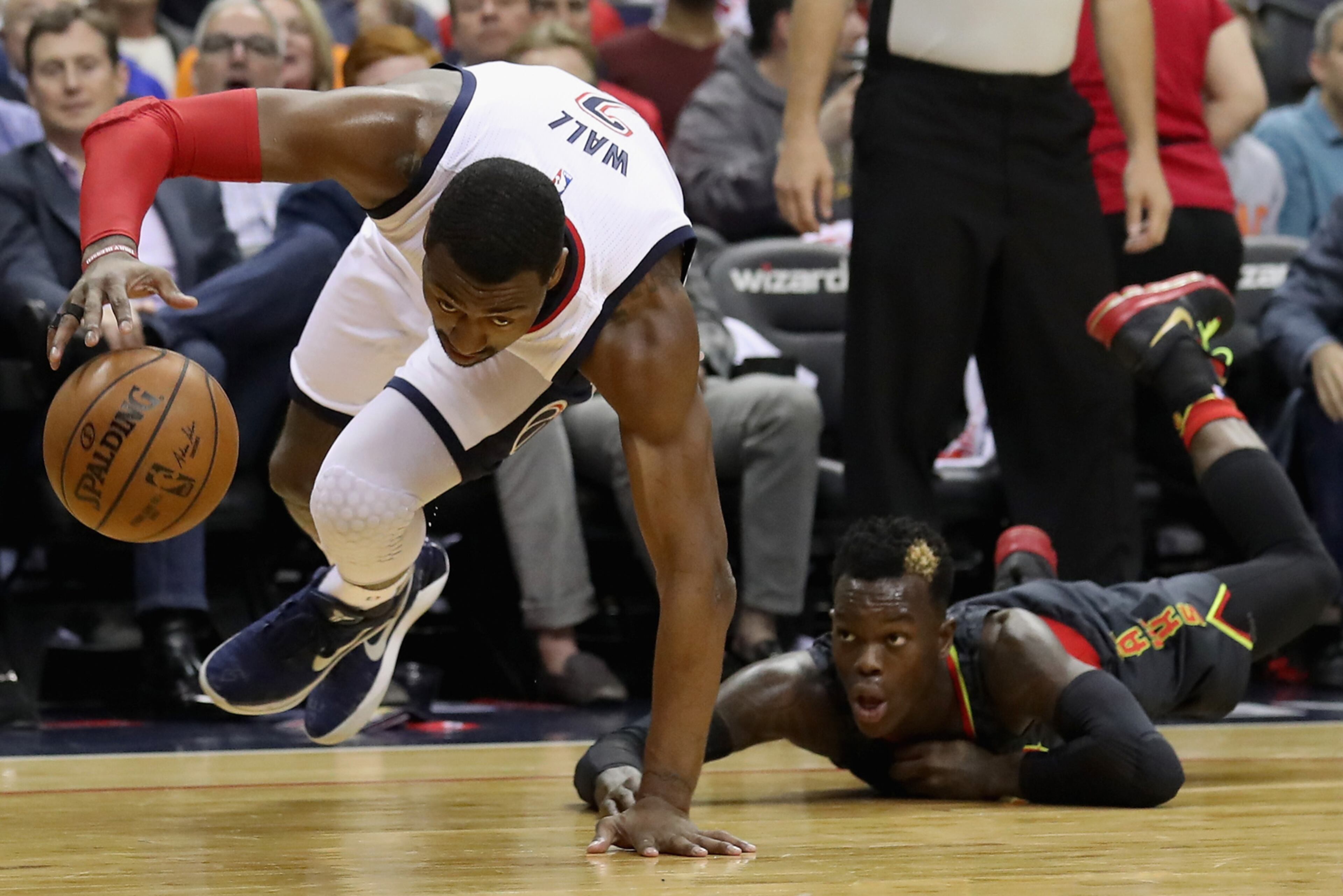 WASHINGTON, DC - APRIL 19: John Wall #2 of the Washington Wizards controls the ball in front of Dennis Schroder #17 of the Atlanta Hawks in the first half of Game Two of the Eastern Conference Quarterfinals during the 2017 NBA Playoffs at Verizon Center on April 19, 2017 in Washington, DC. NOTE TO USER: User expressly acknowledges and agrees that, by downloading and or using this photograph, User is consenting to the terms and conditions of the Getty Images License Agreement. (Photo by Rob Carr/Getty Images)