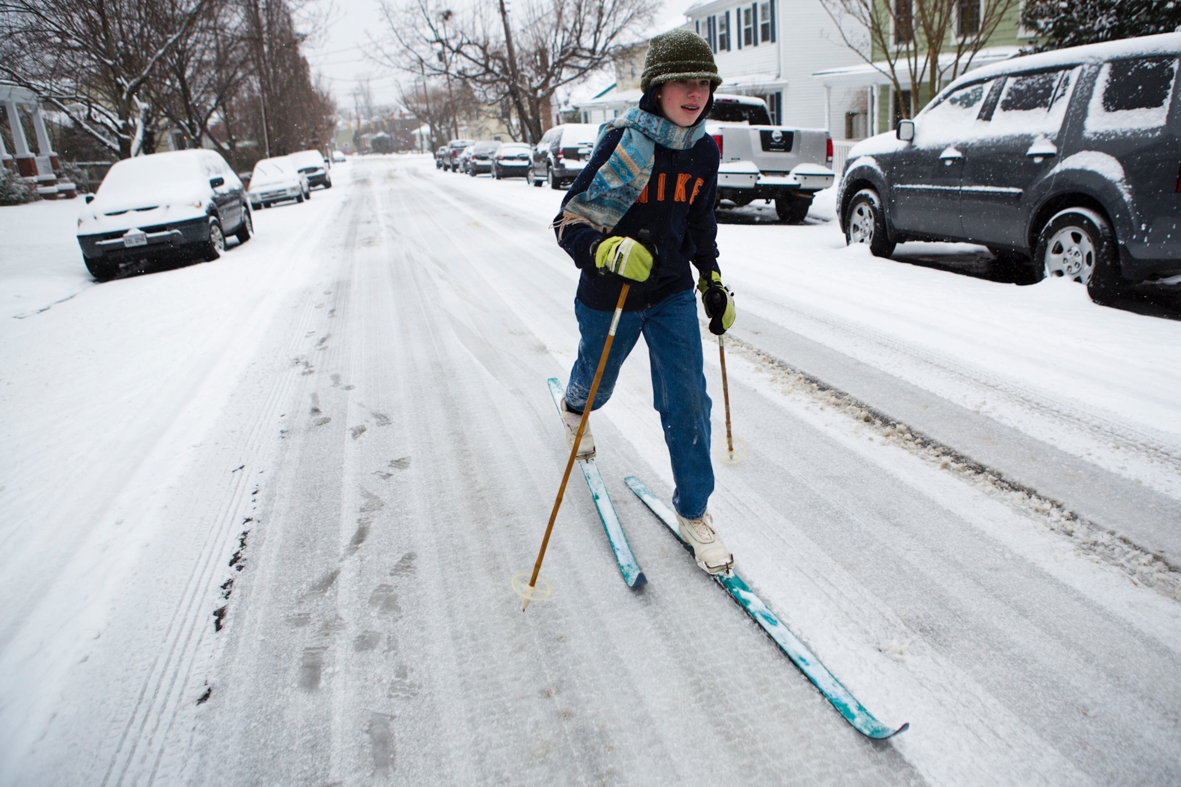 Levi Hoffman, 13, skies down Hanover St. to his friend's house in Fredericksburg, Va during the snowstorm on Monday, March 3, 2014. Winter kept its icy hold on much of the country Monday, with snow falling and temperatures dropping as schools and offices closed and people from the South and Mid-Atlantic to Northeast reluctantly waited out another storm indoors. (AP Photo/The Free Lance-Star, Autumn Parry)