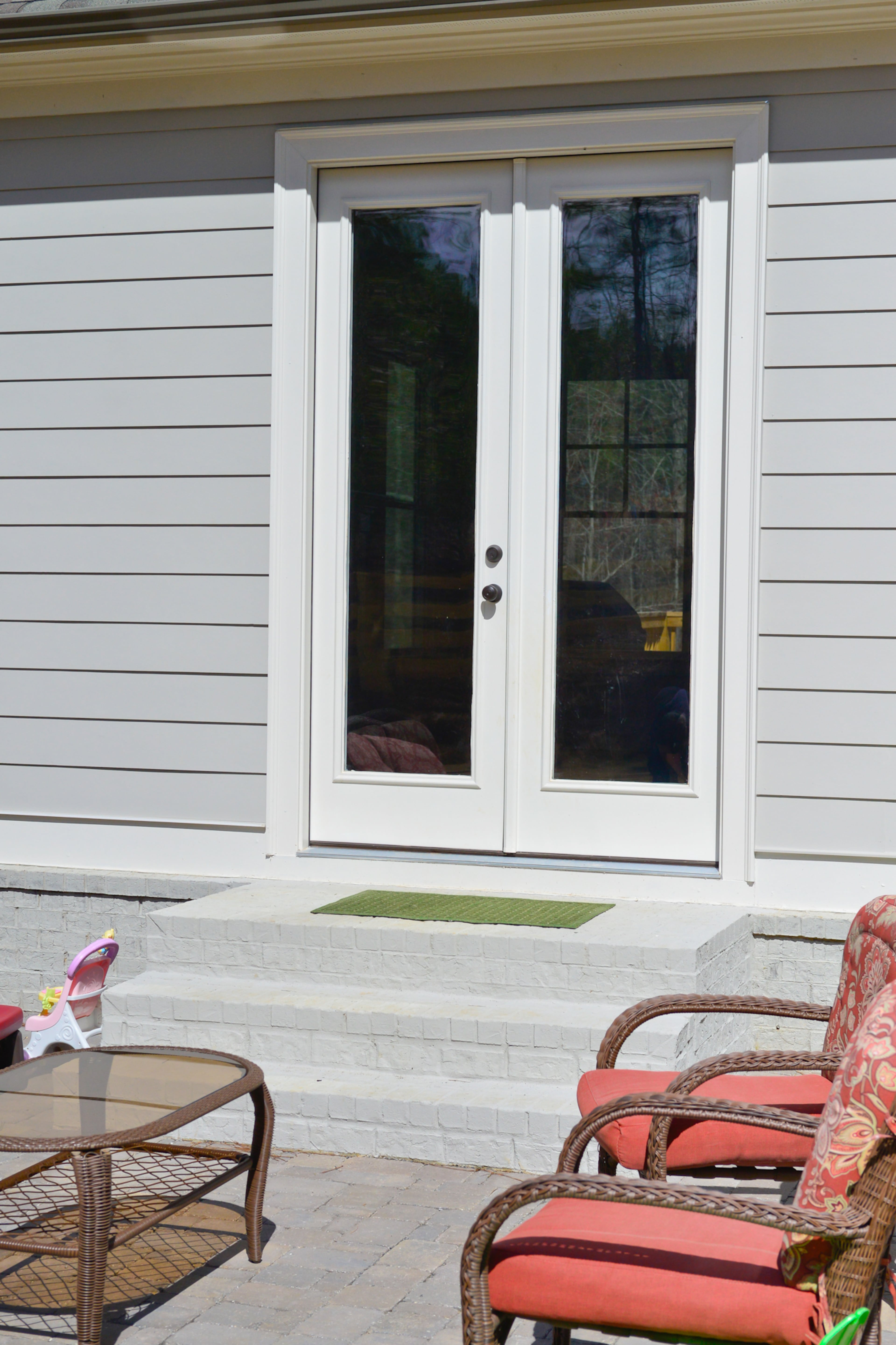 Ceiling details such as exposed beams in the keeping room and a coffered ceiling in the living room, as well as the gray-washed brick on the exterior.Edward Andrews Homes replaced windows with French doors on the first level of Justin and Sophia DeCouto's five-bedroom, four-bath home in Milton's Lake Haven of Crabapple neighborhood.