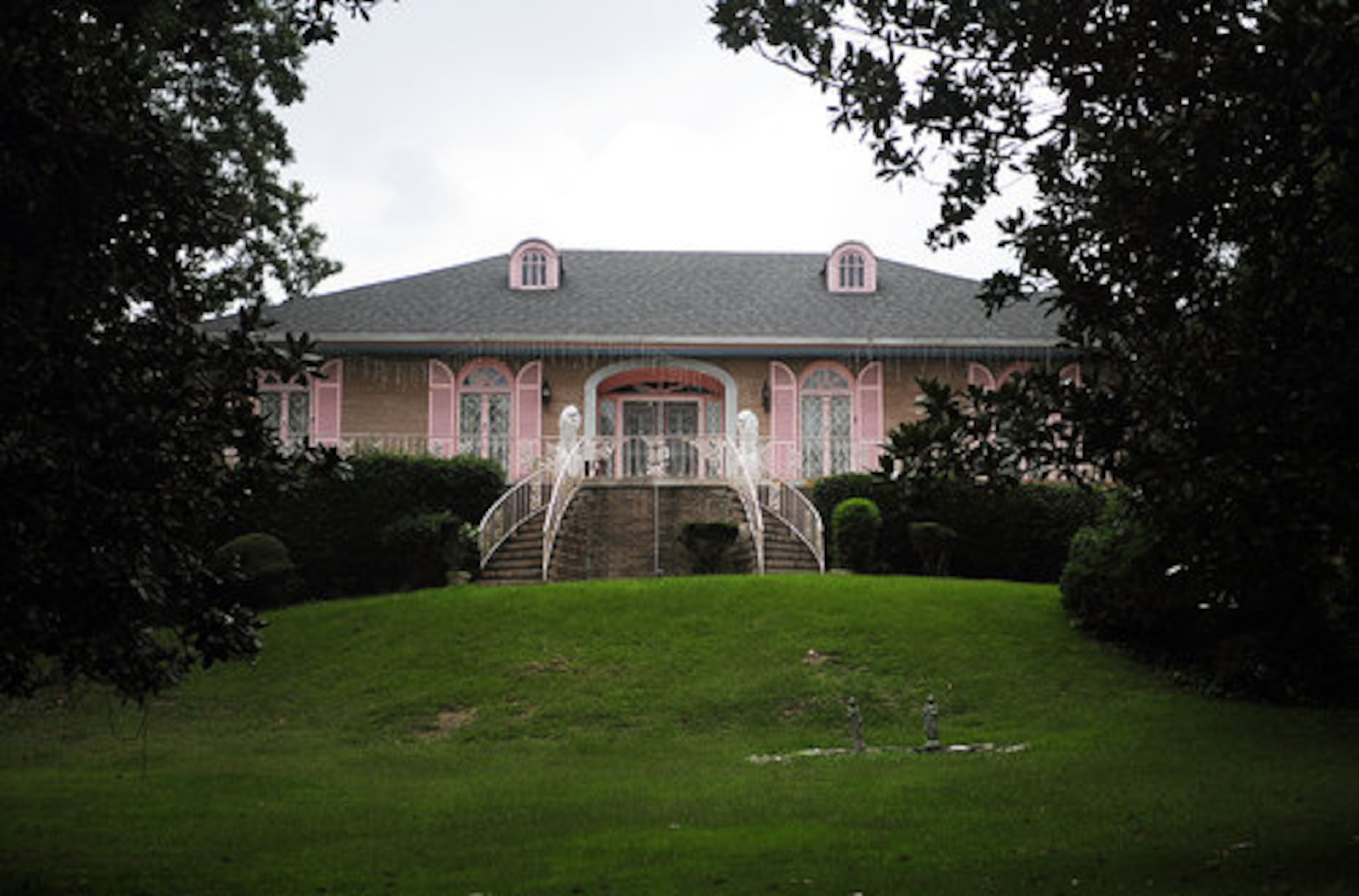 An elaborate home on a hill with pink shutters and lions is one of the better-known houses in the Collier Heights neighborhood in west Atlanta. The state of Georgia has nominated Collier Heights for the National Register of Historic Places.