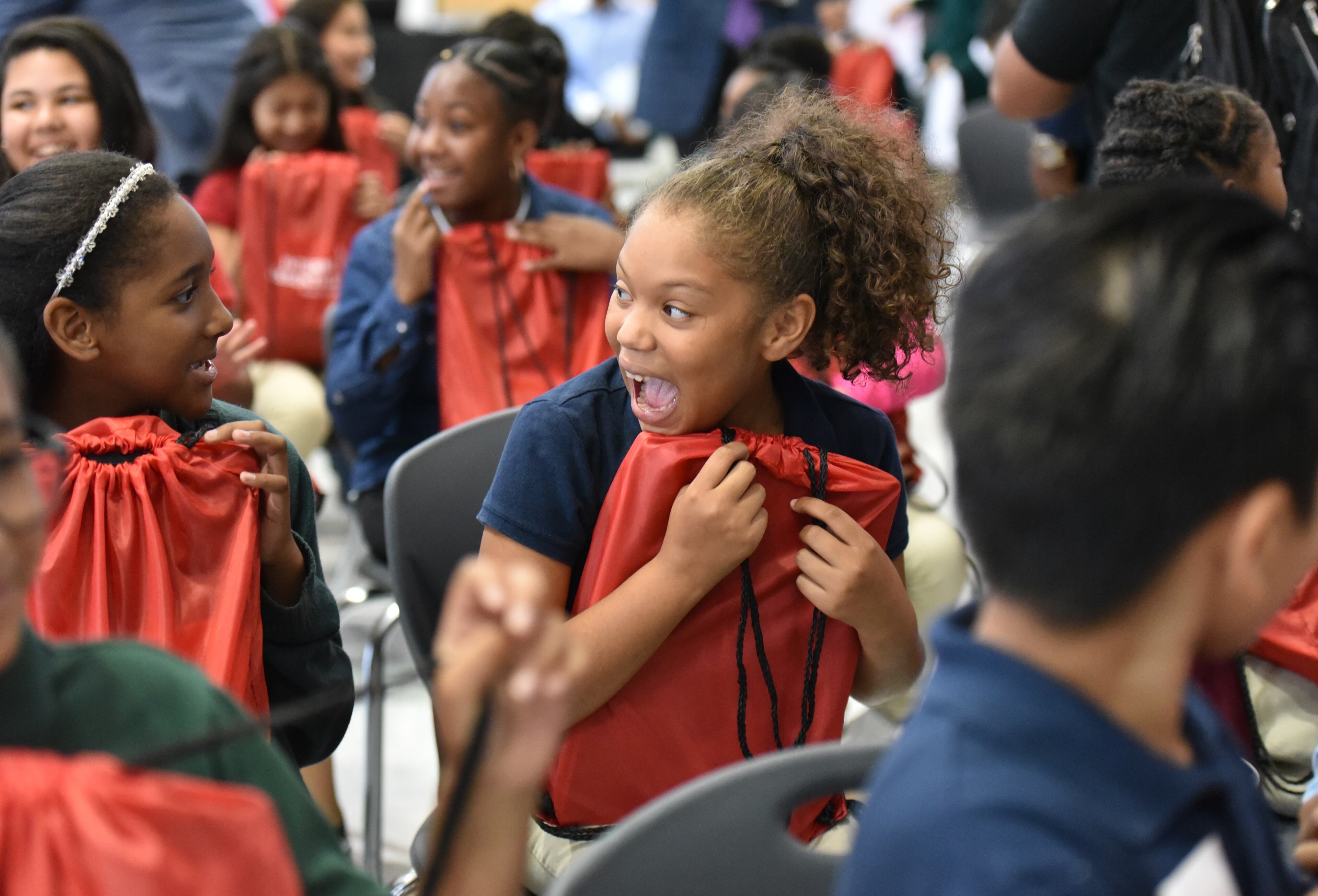 October 4, 2017 Morrow - Madison Inman, 10, reacts as she receives a laptop as part of Internet Essentials program during Internet Essentials Back to School Event at Morrow Middle School on Wednesday, October 4, 2017. Comcast's community investment program, Internet Essentials, is now in its seventh academic year and is most successful broadband adoption initiative for low-income families. Comcast also announced it is donating 100 laptops to students at Morrow Middle School and Unidos Dual Language Charter School, located in the Clayton County School District. HYOSUB SHIN / HSHIN@AJC.COM