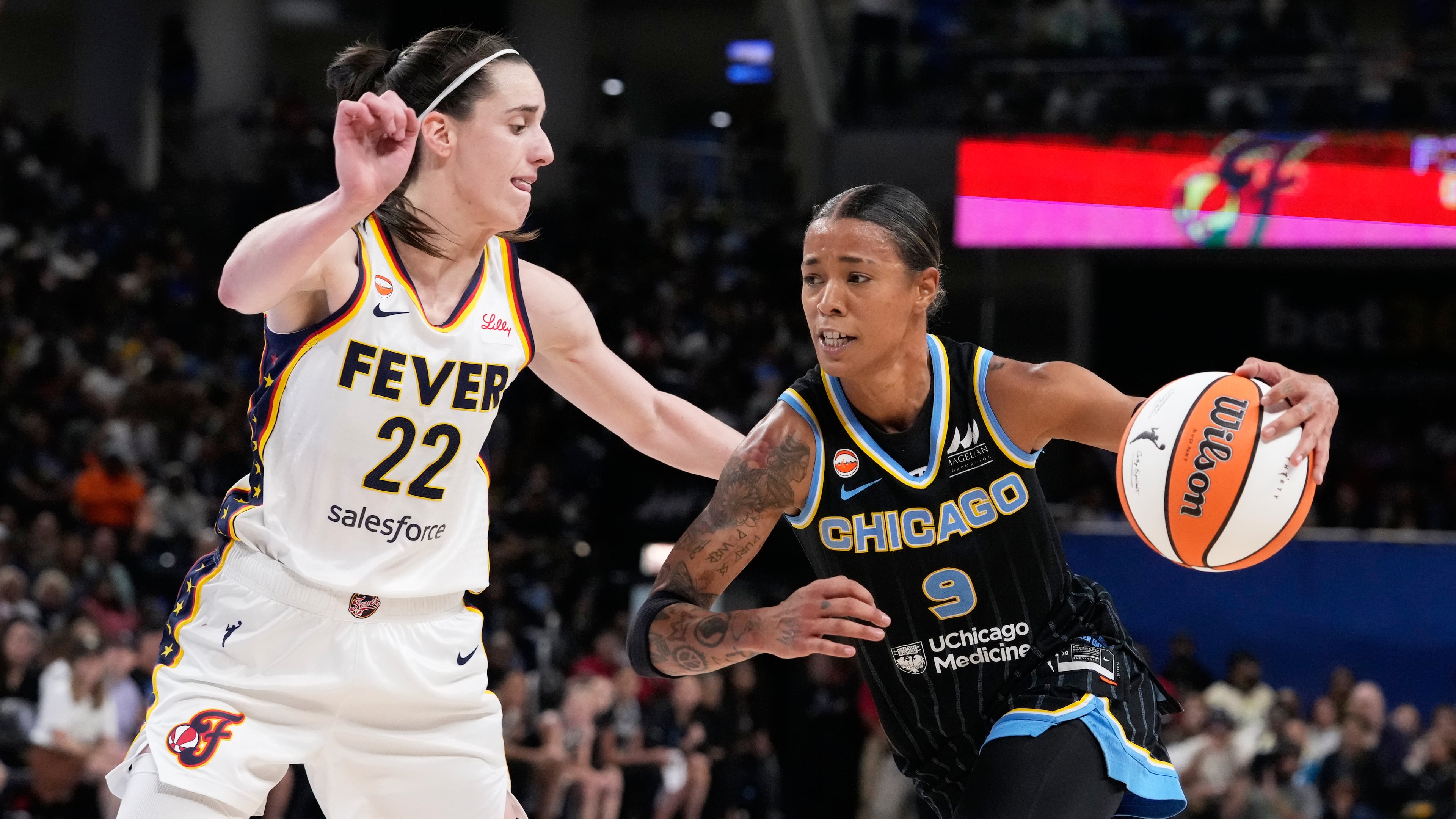 Chicago Sky guard Natasha Cloud, right, drives against Indiana Fever guard Caitlin Clark during the second half of a WNBA basketball game Sunday, Aug. 23, 2026, in Chicago. (AP Photo/Nam Y. Huh)