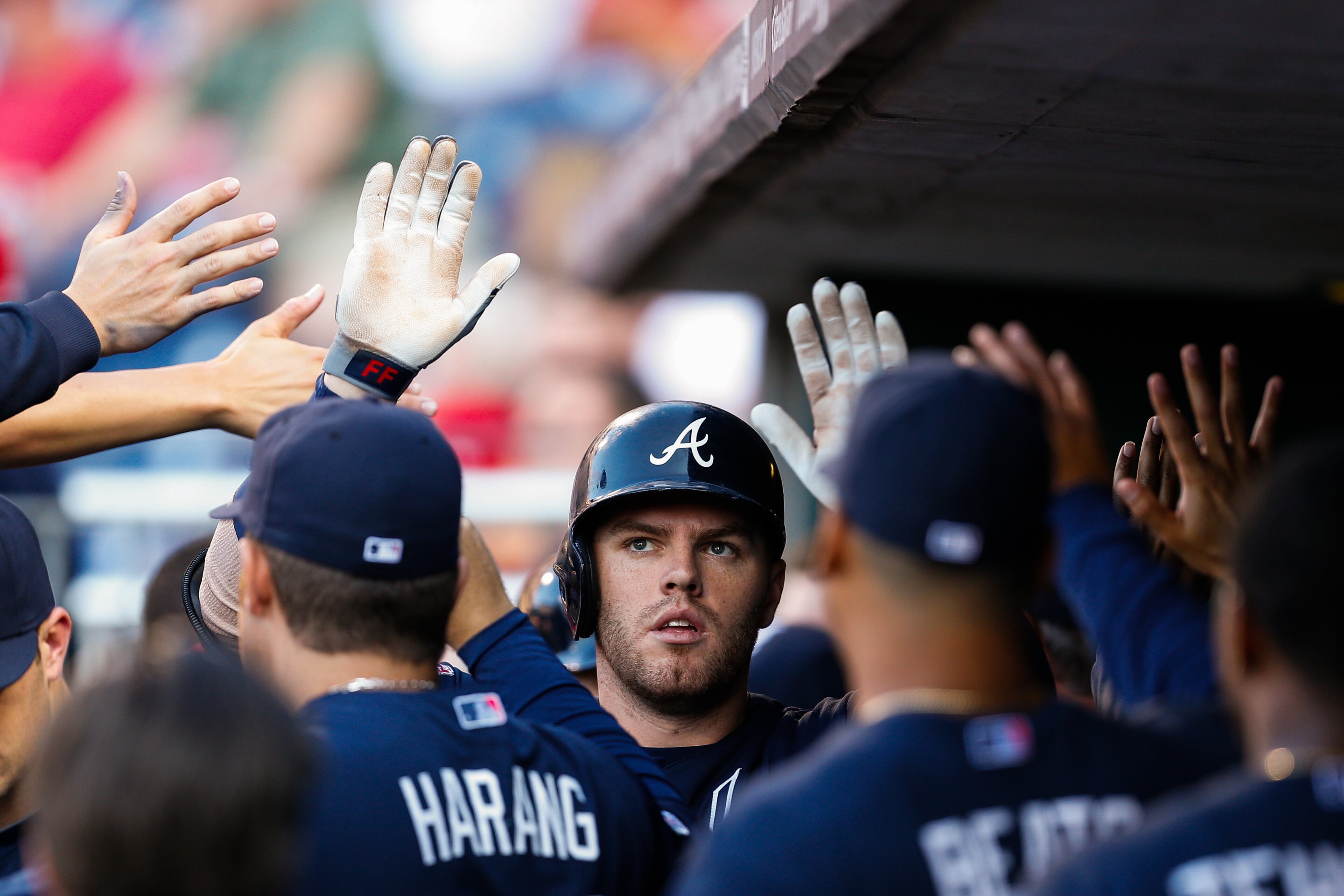 PHILADELPHIA, PA - JUNE 27: Freddie Freeman #5 of the Atlanta Braves is congratulated by teammates in the dugout after hitting a three-run home run in the first inning of the game against the Philadelphia Phillies at Citizens Bank Park on June 27, 2014 in Philadelphia, Pennsylvania. (Photo by Brian Garfinkel/Getty Images)