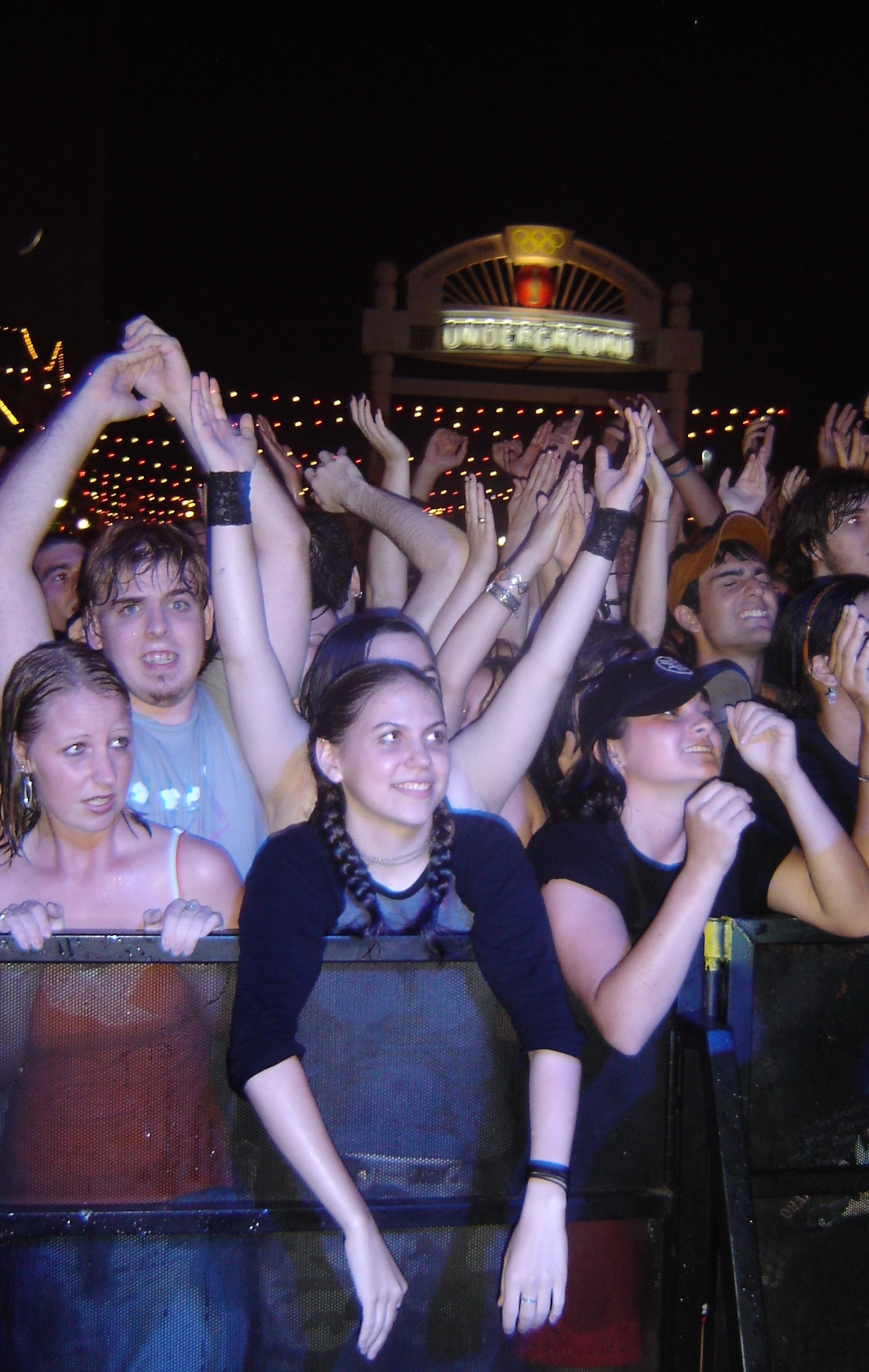 050709 ATLANTA, GA - At Underground Atlanta, Katherine Lundy, 20, of Lilburn (center, with ponytails) enjoys Cake, the headliner for 99X's Downtown Rocks six week free concert series. (Rodney Ho/AJC staff)