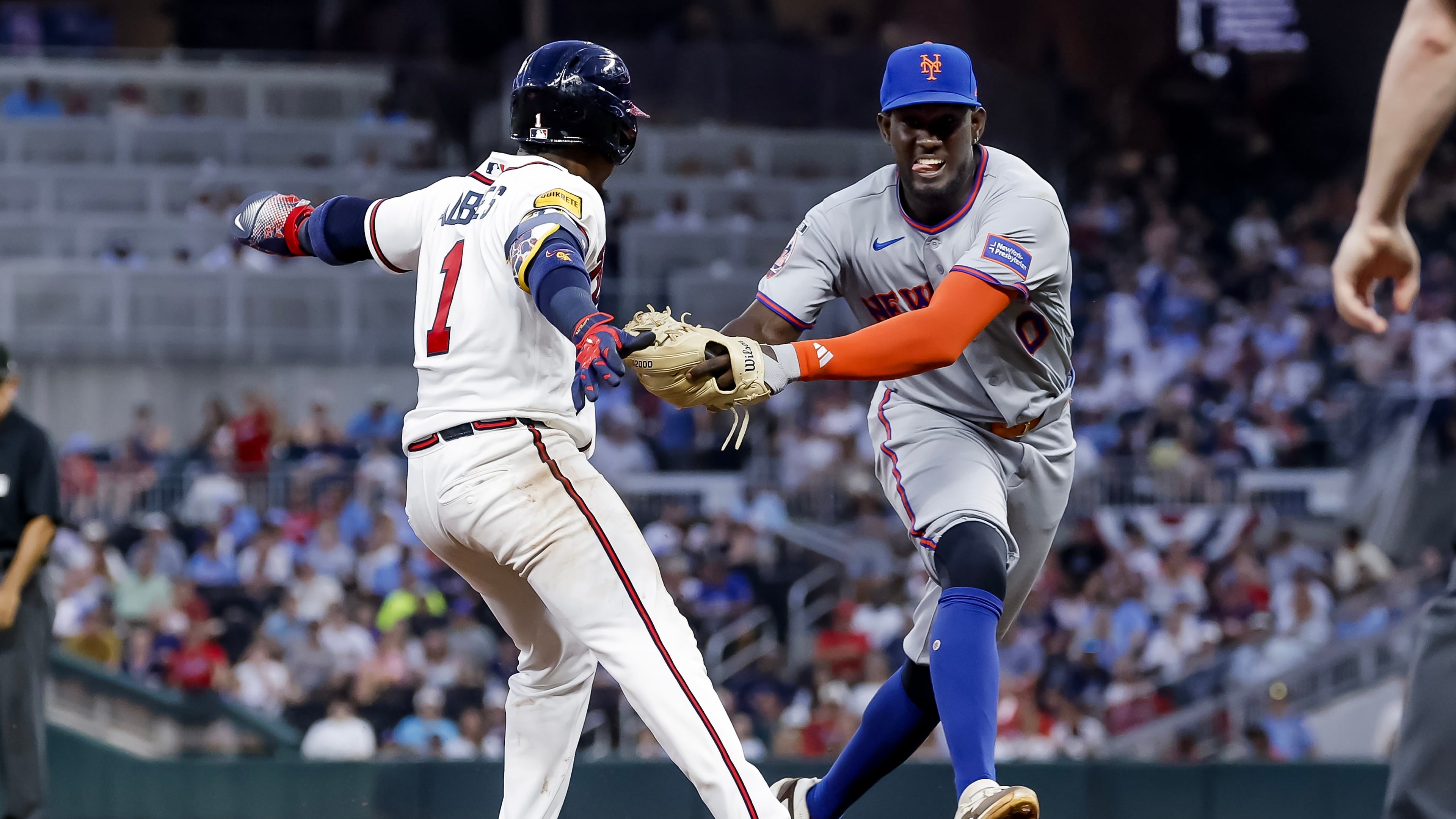 New York Mets shortstop Ronny Mauricio, right, tags out Atlanta Braves' Ozzie Albies, left, between second base and third during the fifth inning of a baseball game, Monday, July 6, 2026, in Atlanta. (AP Photo/Erik S. Lesser)
