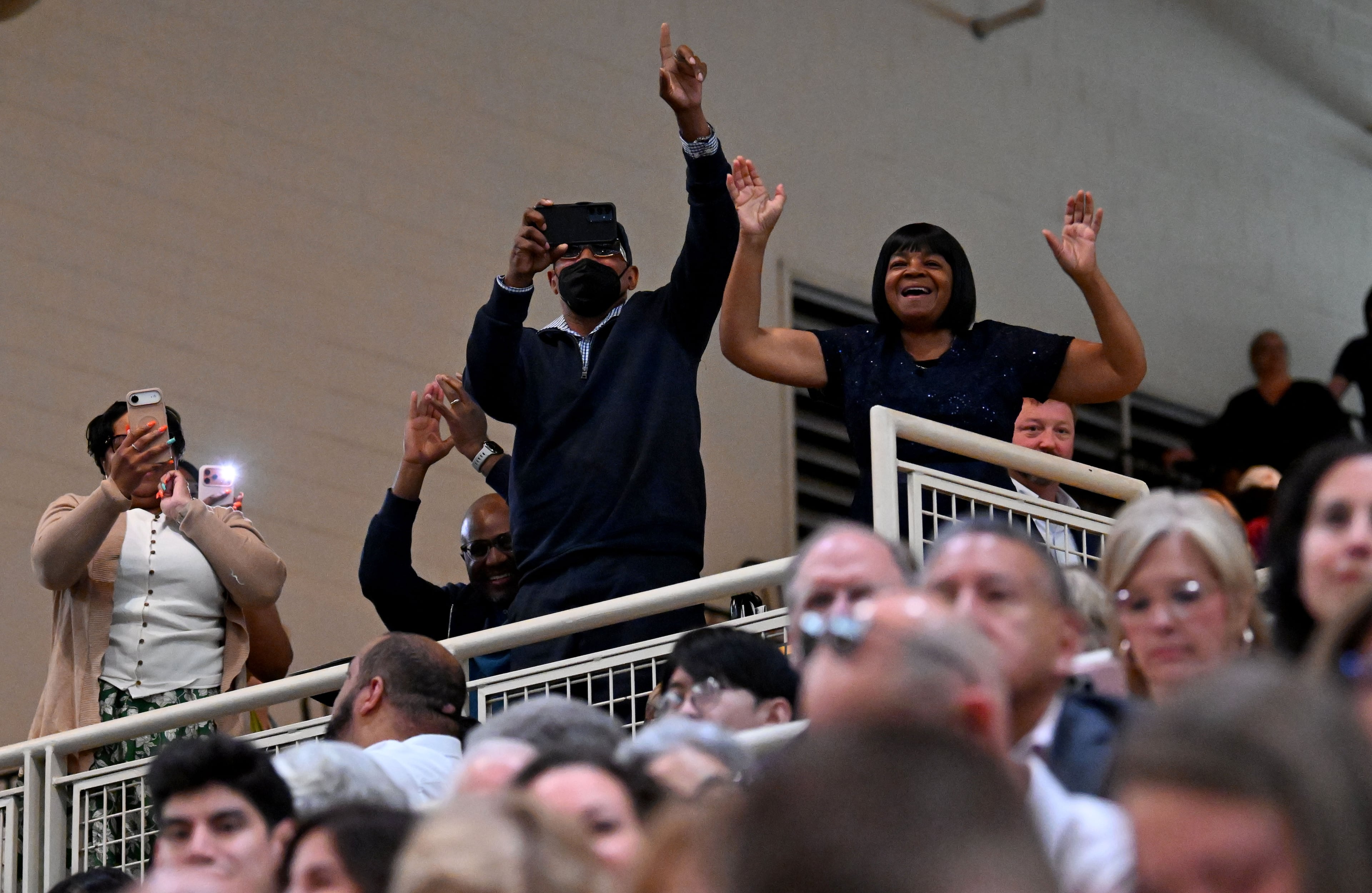 Family and friends express their excitement and pride when they spot their graduates during Kennesaw State’s commencement. (Hyosub Shin/AJC)