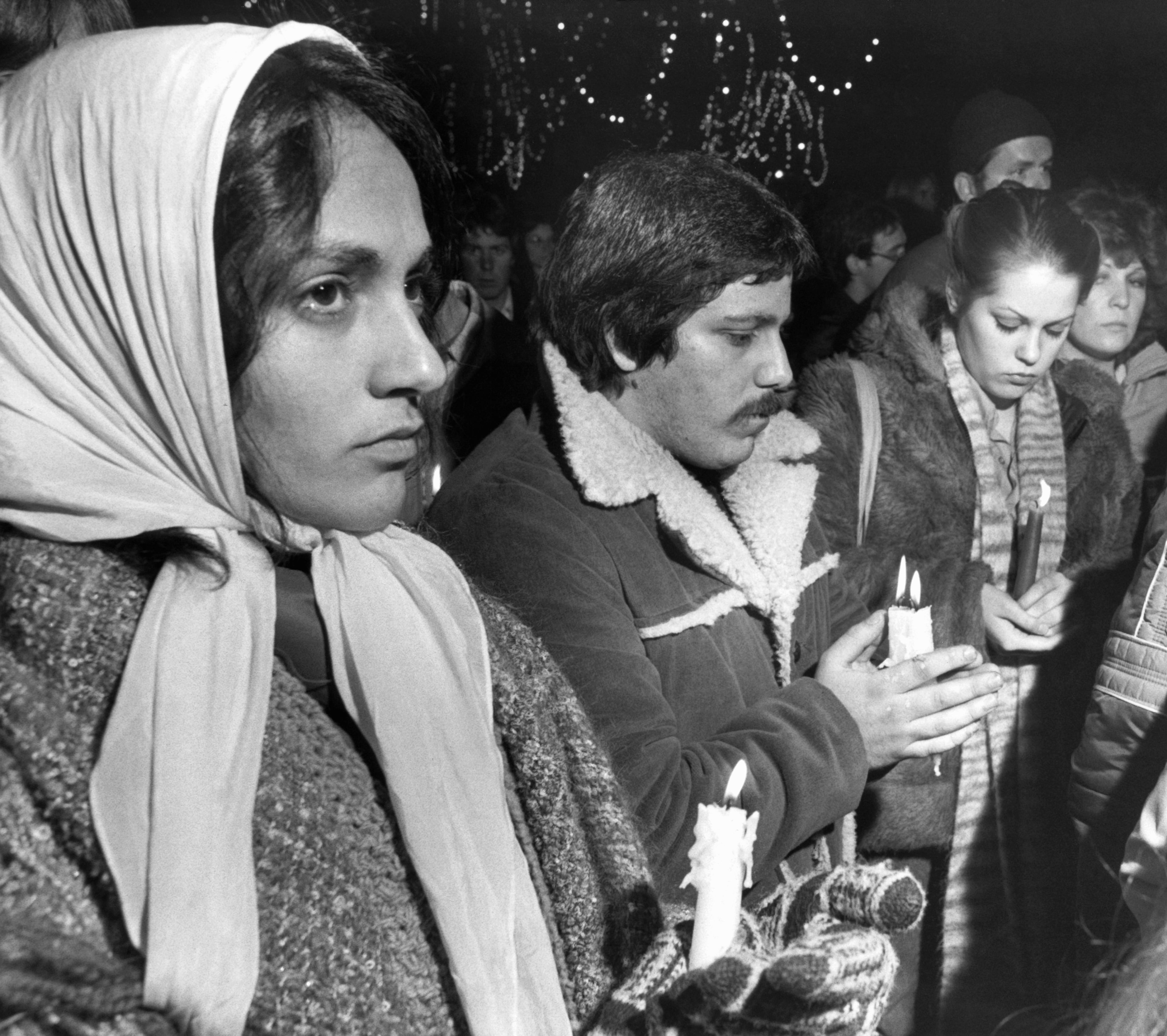In this Dec. 10, 1980, file photo, people participate in a candlelight vigil on Boston Common in Boston, Mass., in memory of musician John Lennon. Thirty-five years ago on Dec. 8, Mark David Chapman shot and killed Lennon, a former Beatles member. (AP Photo/McDonnell, File)
