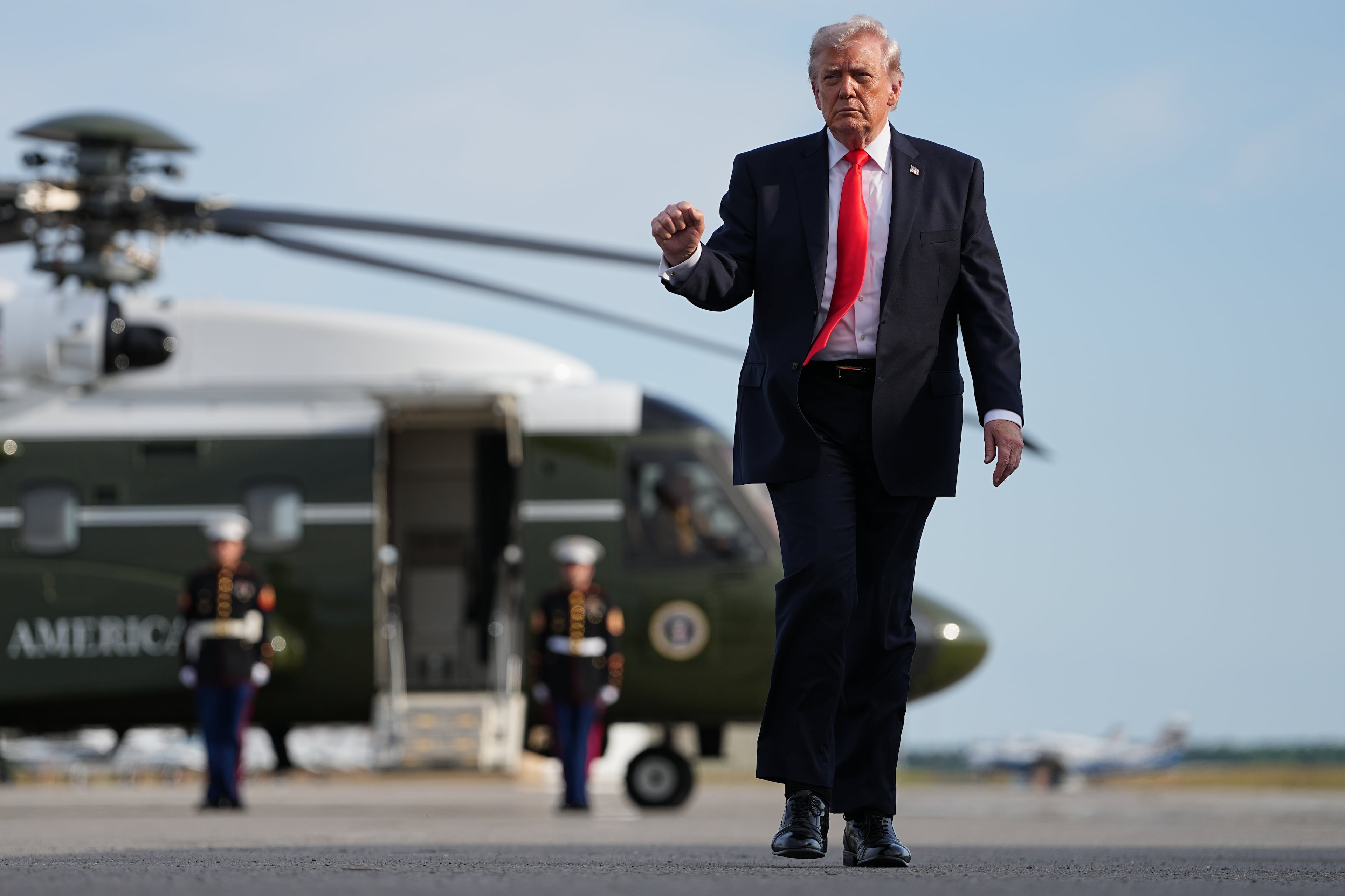 President Donald Trump walks from Marine One to board Air Force One at Ocala International Airport, in Ocala, Fla., on Friday. (Matt Rourke/AP)