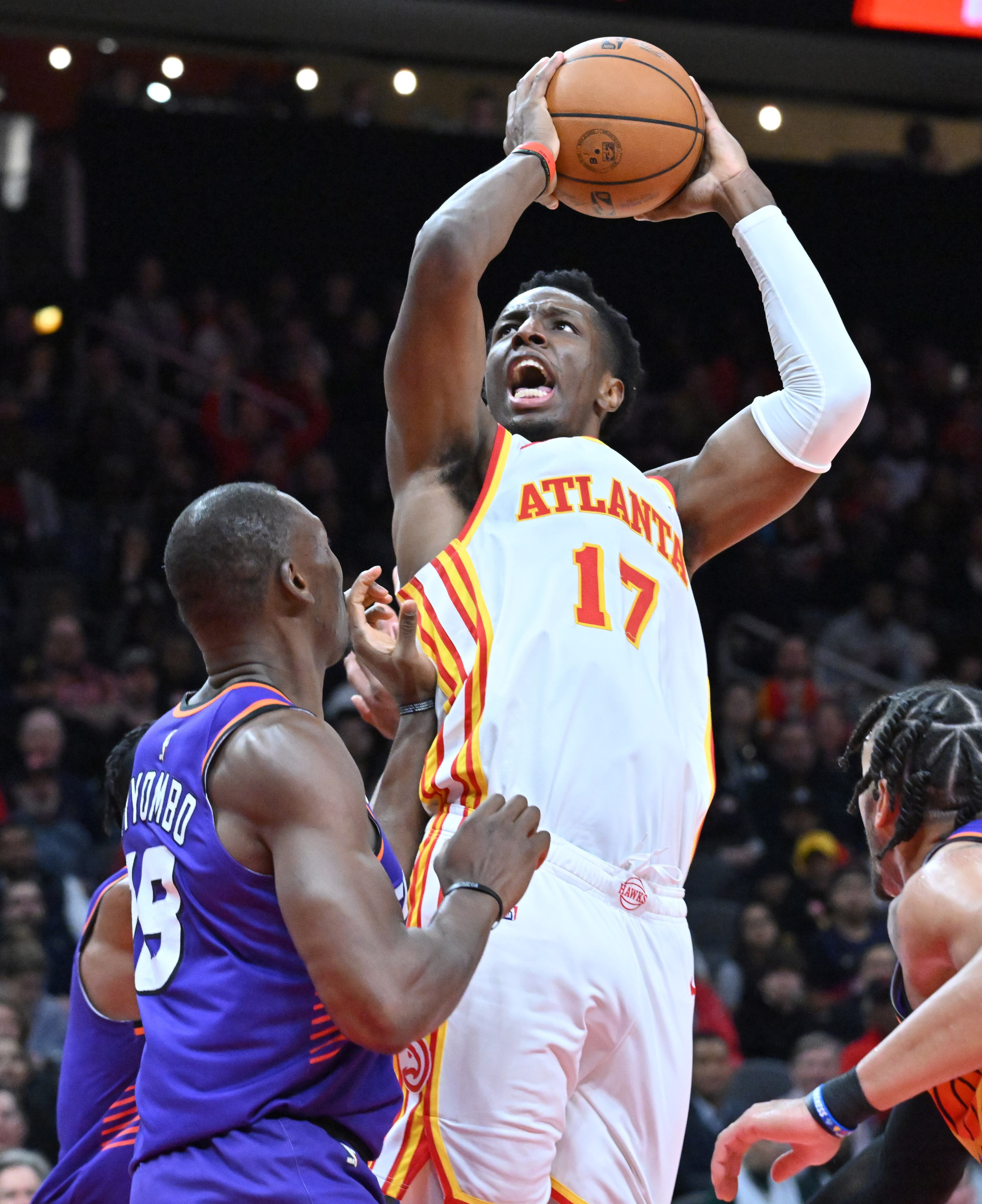 Atlanta Hawks' forward Onyeka Okongwu (17) shoots against Phoenix Suns' center Bismack Biyombo (left). (Hyosub Shin / Hyosub.Shin@ajc.com)