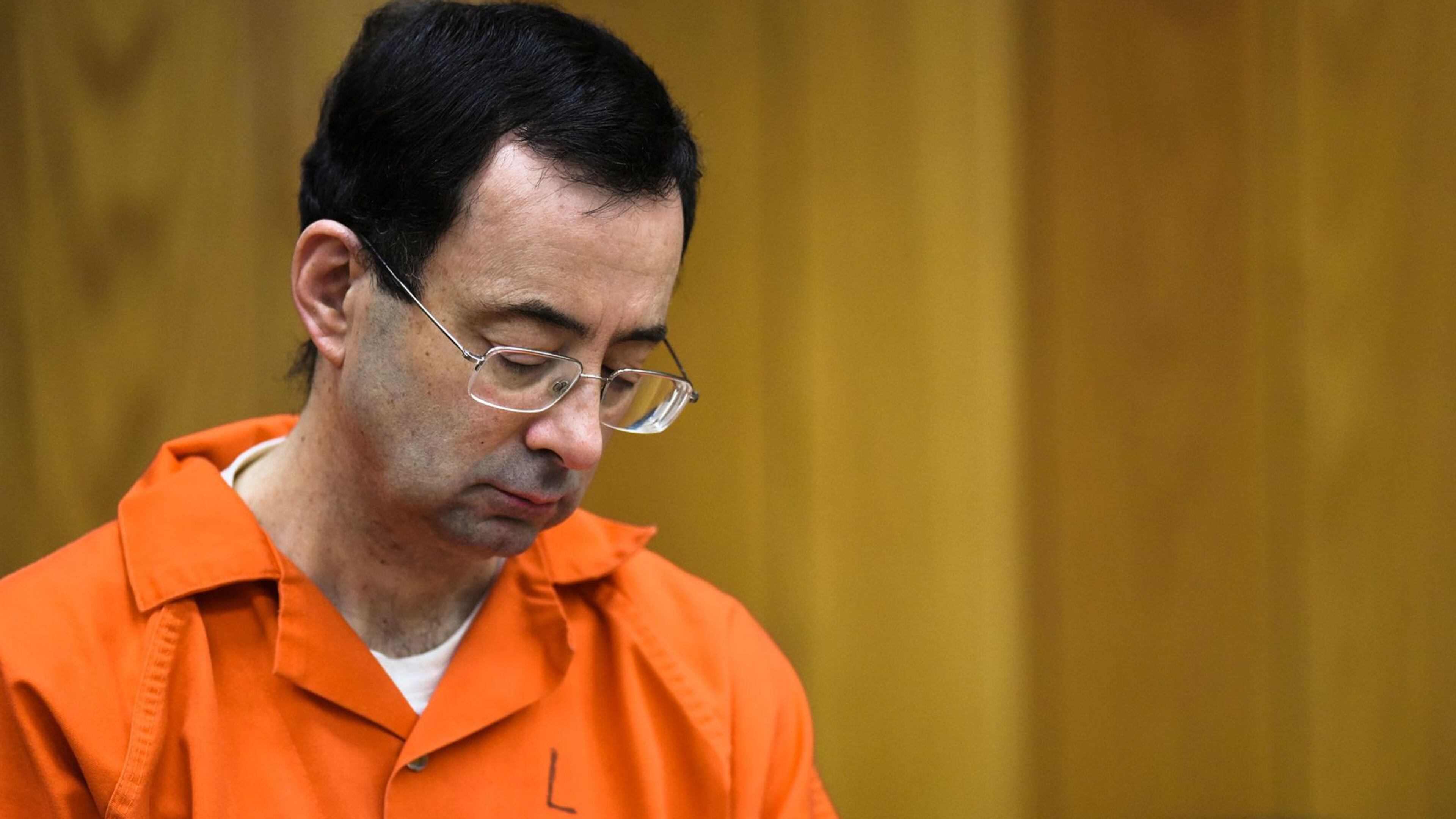 Larry Nassar looks down Monday, Feb. 5, 2018, on the third and final day of sentencing in Eaton County Court in Charlotte, Mich. He was sentenced to 40 to 125 years in prison. He was transferred to federal custody Thursday, Feb. 8, 2018.
