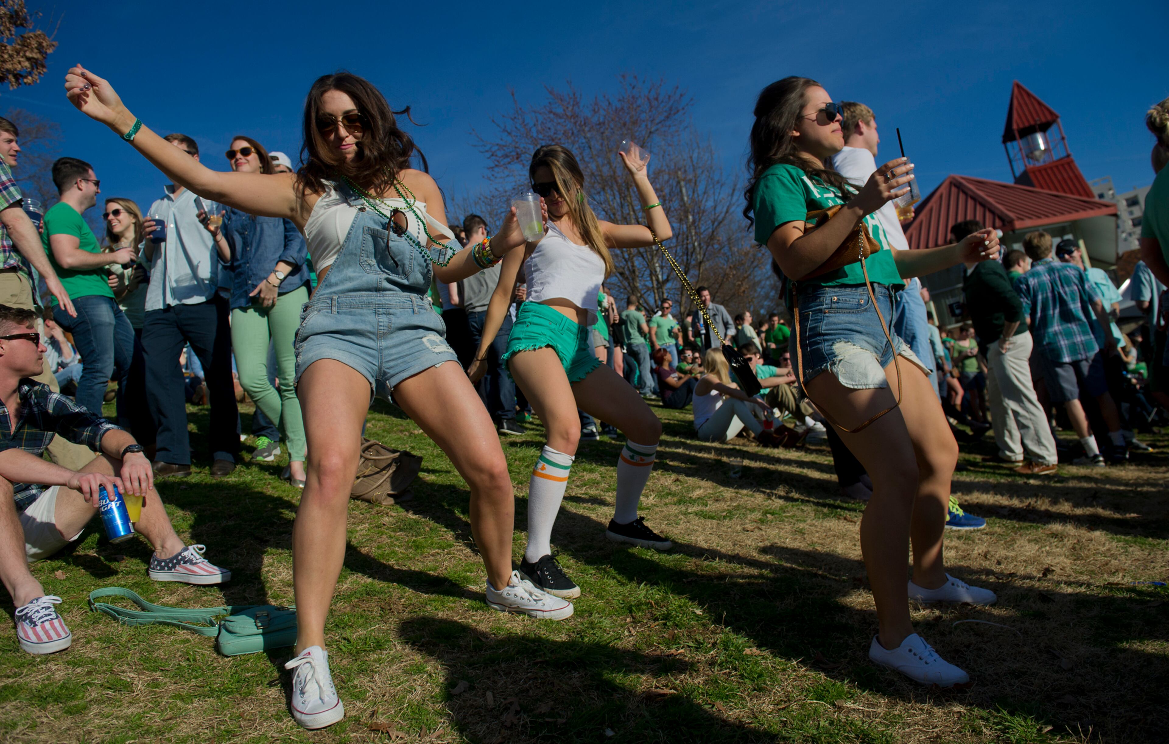 Caitlin Stober (left), Dara Freudenthal and Kirstie Castaneria dance during the 4th annual Lepre*CON at Park Tavern in Atlanta on Saturday, March 8, 2014. Hundreds of people came to the pub at Piedmont Park to celebrate St. Patrick's Day.