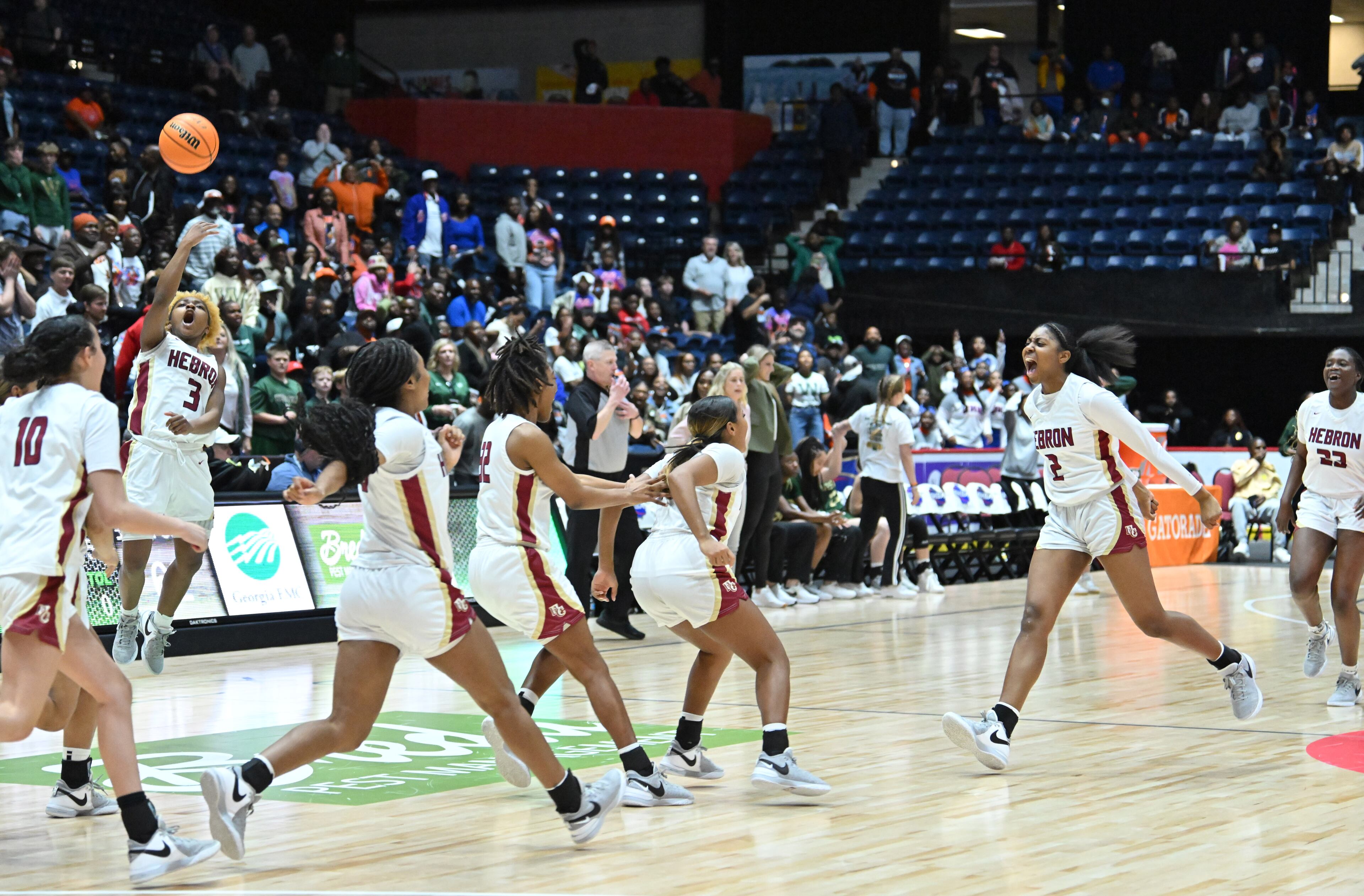 Hebron Christian players celebrate their win over Wesleyan during GHSA Basketball Class 3A Girl’s State Championship game at the Macon Centreplex, Friday, Mar. 8, 2024, in Macon. Hebron Christian won 62-60 over Wesleyan. (Hyosub Shin / Hyosub.Shin@ajc.com)