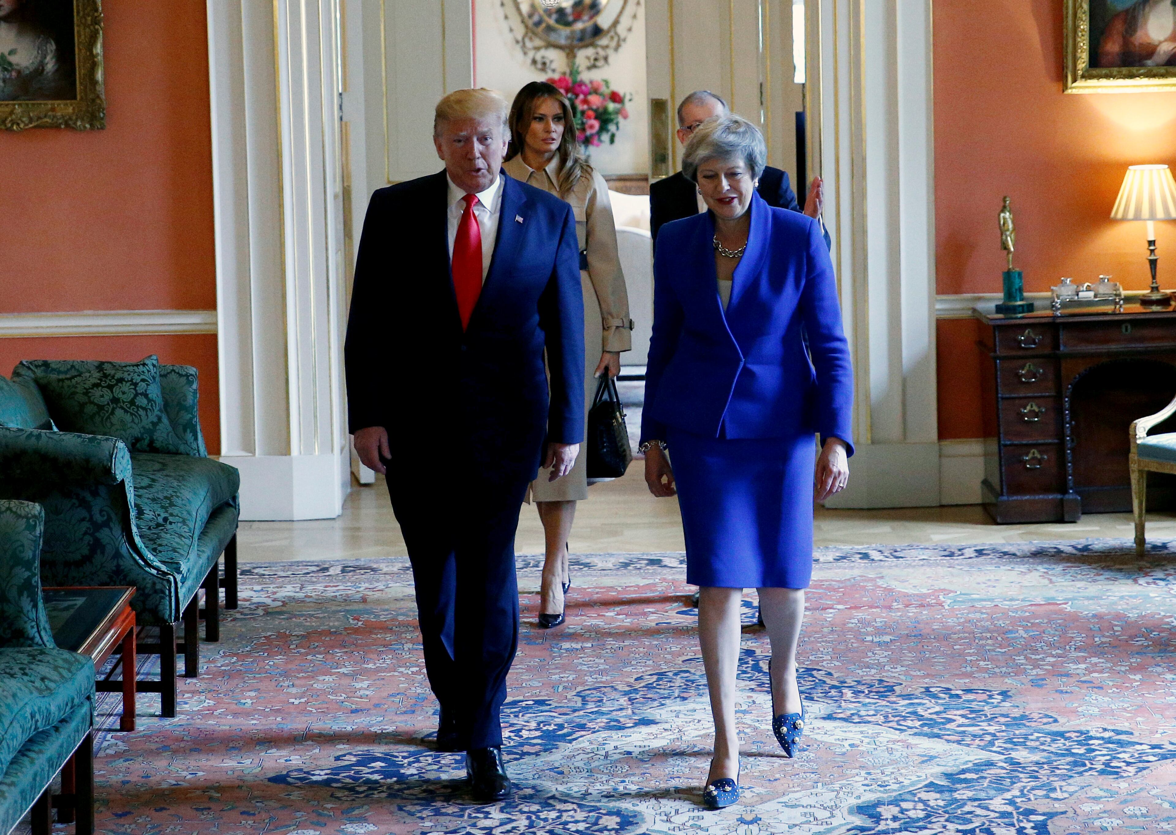 U.S. President Donald Trump walks with Britain's Prime Minister Theresa May, followed by U.S. first lady Melania Trump and Prime Minister's husband Philip May, in Downing Street, as part of Trump's State Visit in London, Tuesday June 4, 2019. U.S. President Donald Trump joins British Prime Minister Theresa May for a day of talks Tuesday. (Henry Nicholls/Pool via AP)