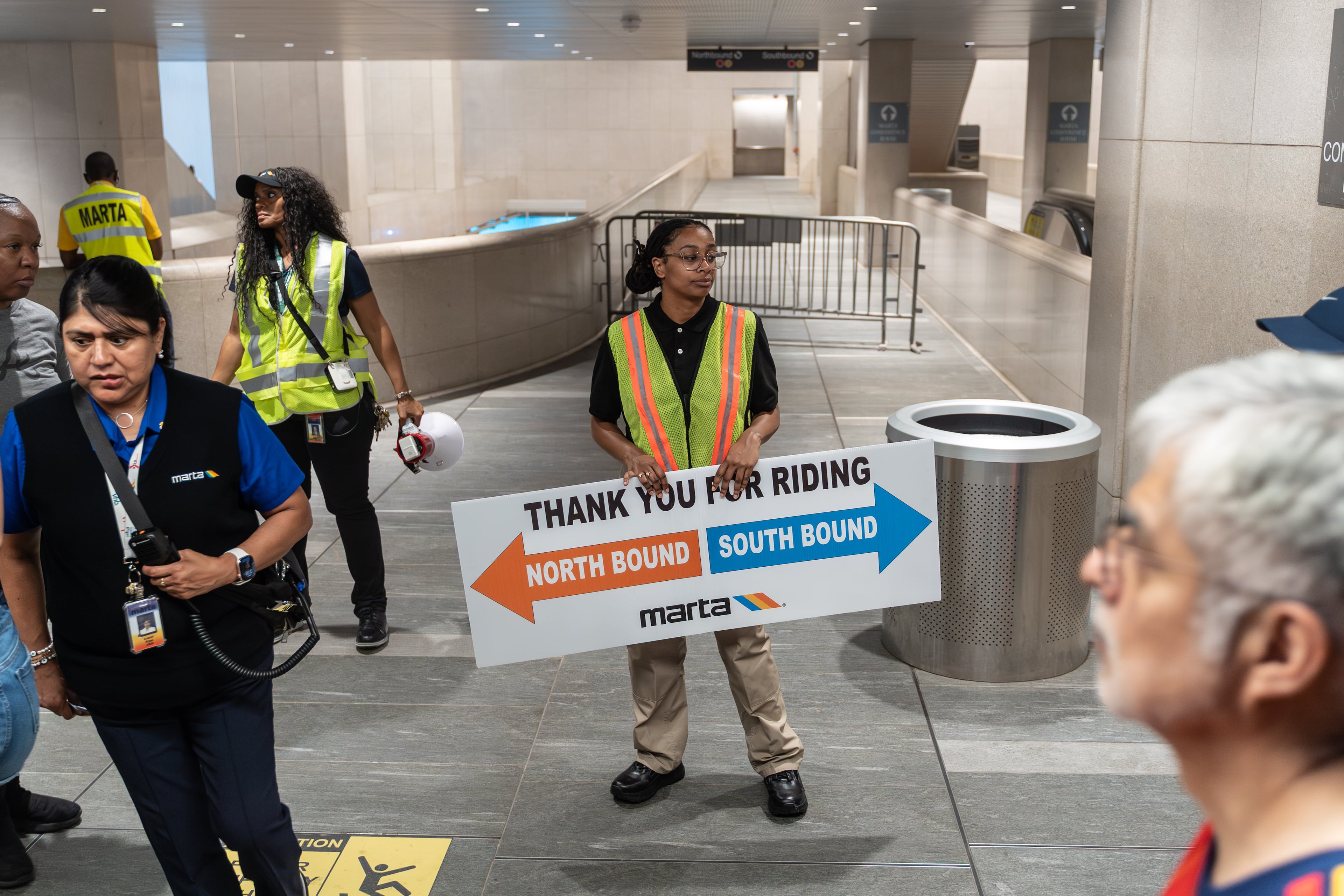 A MARTA employee holds a sign inside the Five Points MARTA station as fans attend the first FIFA match held in Atlanta on Monday, June 15, 2026. (Ben Hendren for the AJC)