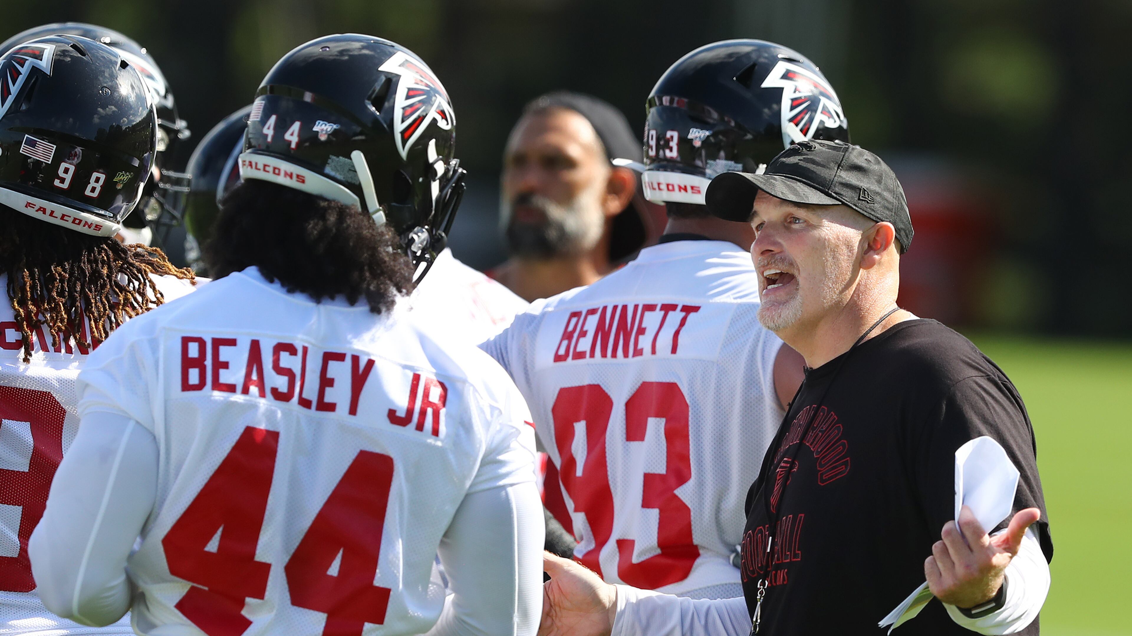 July 22, 2019 Flowery Branch: Falcons head coach Dan Quinn works with Vic Beasley Jr. on his defense after a play during the first practice at training camp on Monday, July 22, 2019, in Flowery Branch. Curtis Compton/ccompton@ajc.com