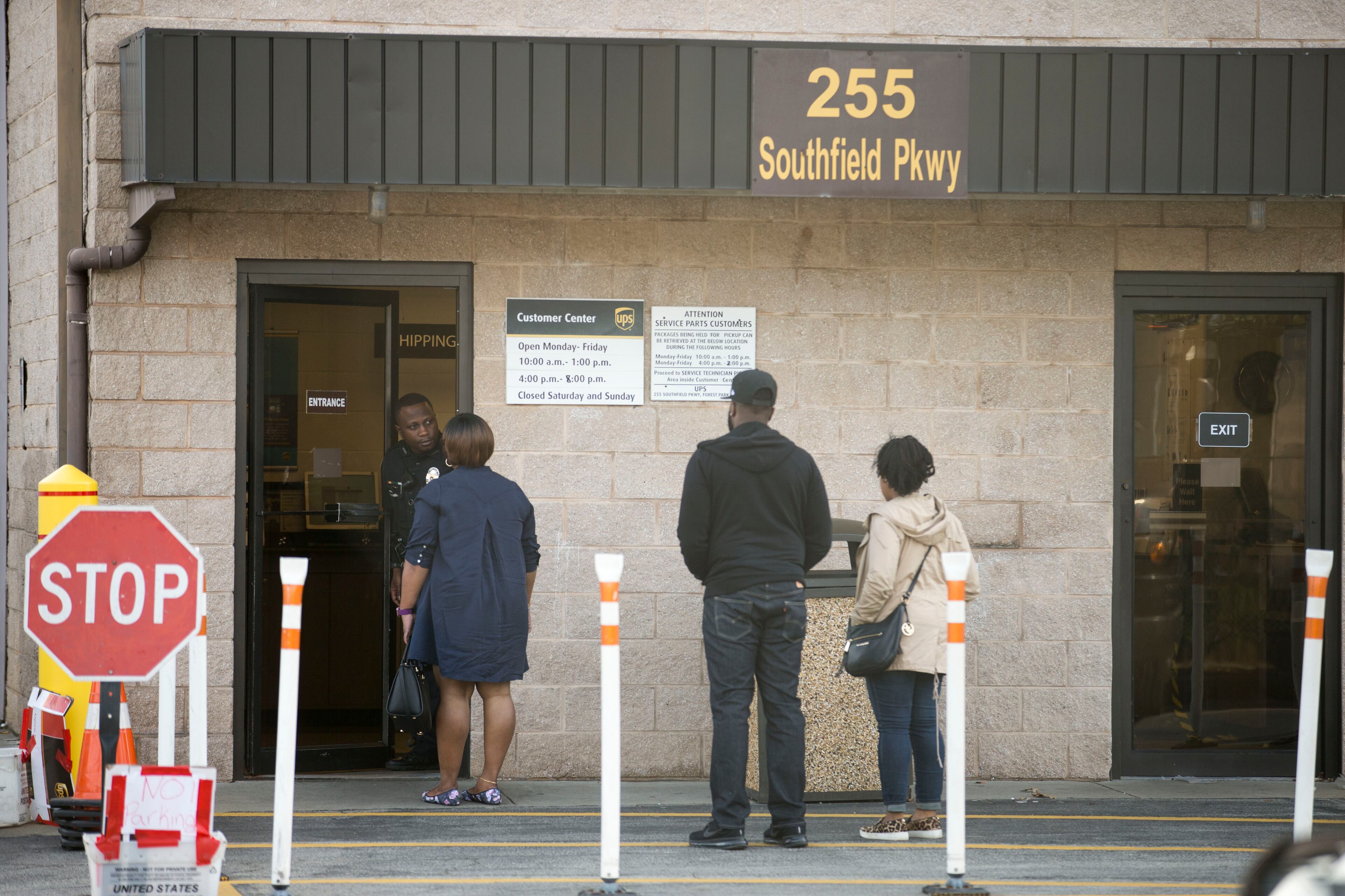 12/26/2017 -- Forest Park, GA, - A Clayton County police officer turns away pedestrians at the entrance of the UPS customer center in Forest Park, Tuesday, December 26, 2017. The officer informed customers that the customer center would not be accepting any more business around 2:50 Tuesday afternoon. The center stayed open a couple hours after its regular closing time to assist customers who had not received their orders before the Christmas holiday. ALYSSA POINTER/ALYSSA.POINTER@AJC.COM