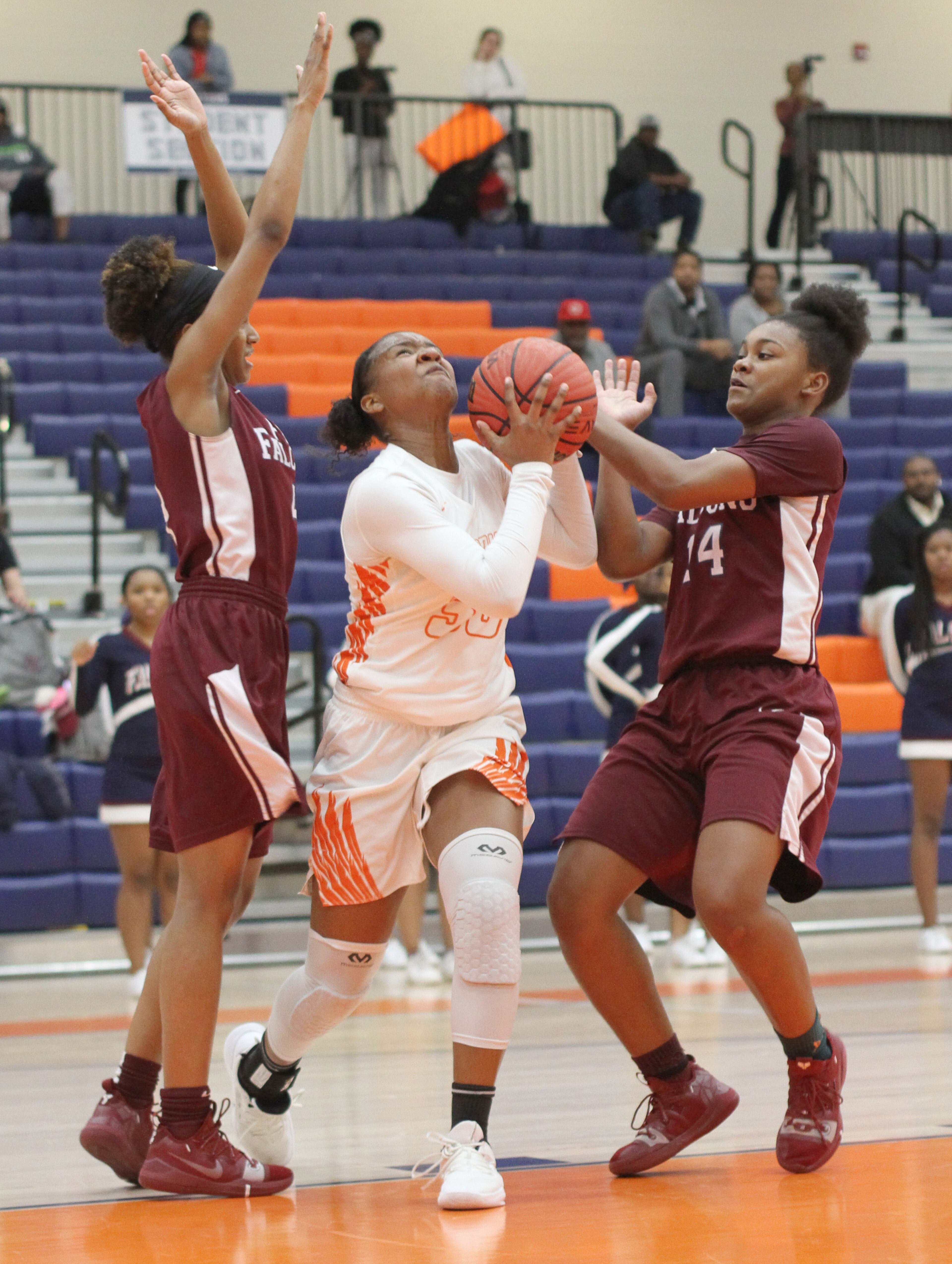 North Cobb High School player Sydney Thomas looks to the basket while being guarded by Pebblebrook High School players Cameron Brown (L) and Milana Holmes (R) during the first round of the girls' high school basketball tournament at North Cobb High School in Kennesaw February 15, 2019. STEVE SCHAEFER / SPECIAL TO THE AJC