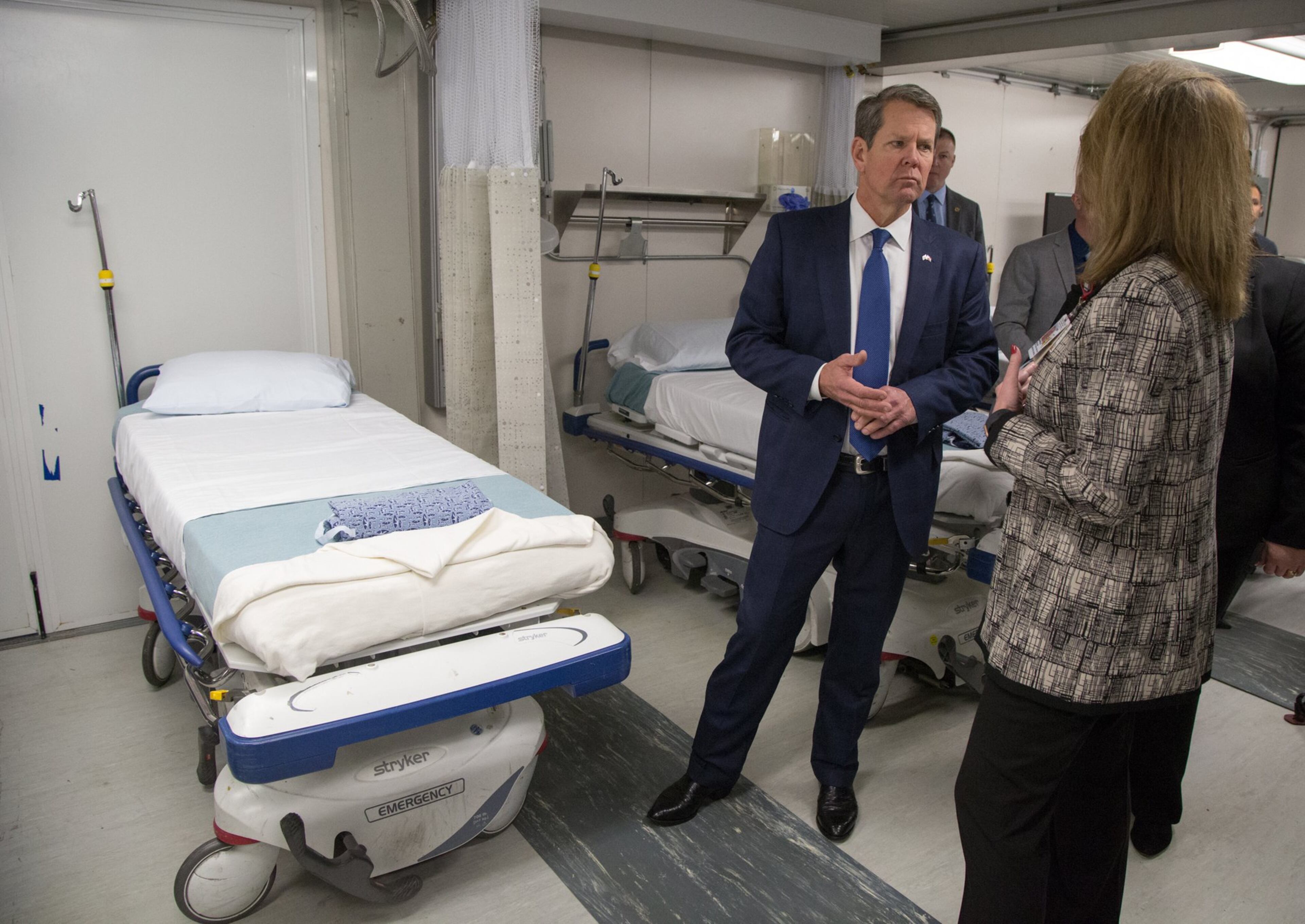 Georgia Governor Brian Kemp talks to Grady's Michelle Wallace inside the mobile ER unit. (Photo by Phil Skinner)