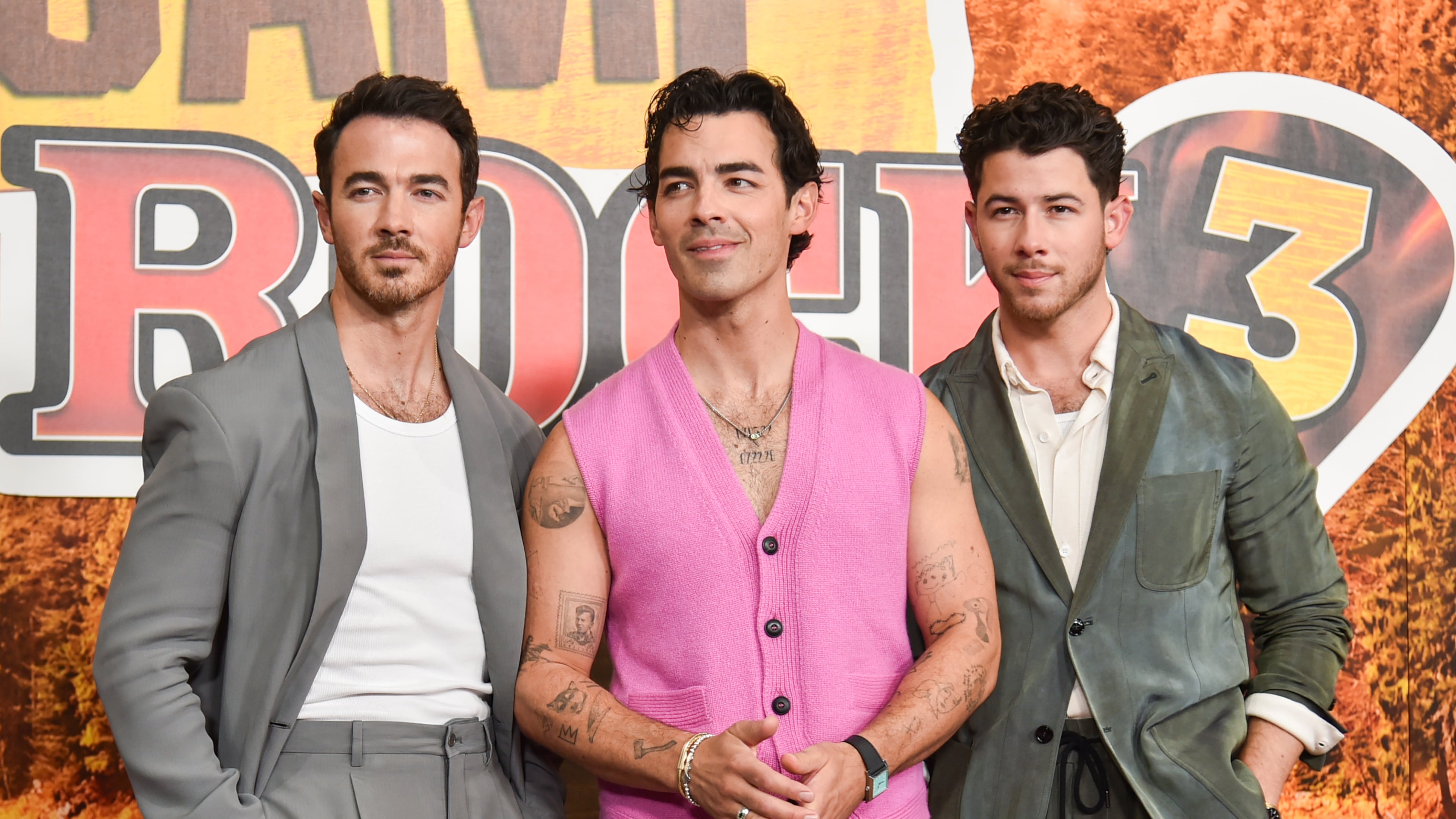 Kevin Jonas, from left, Joe Jonas, and Nick Jonas arrive at the premiere of "Camp Rock 3" on Monday, Aug. 10, 2026, at The Walt Disney Studios in Burbank, Calif. (Photo by Richard Shotwell/Invision/AP)