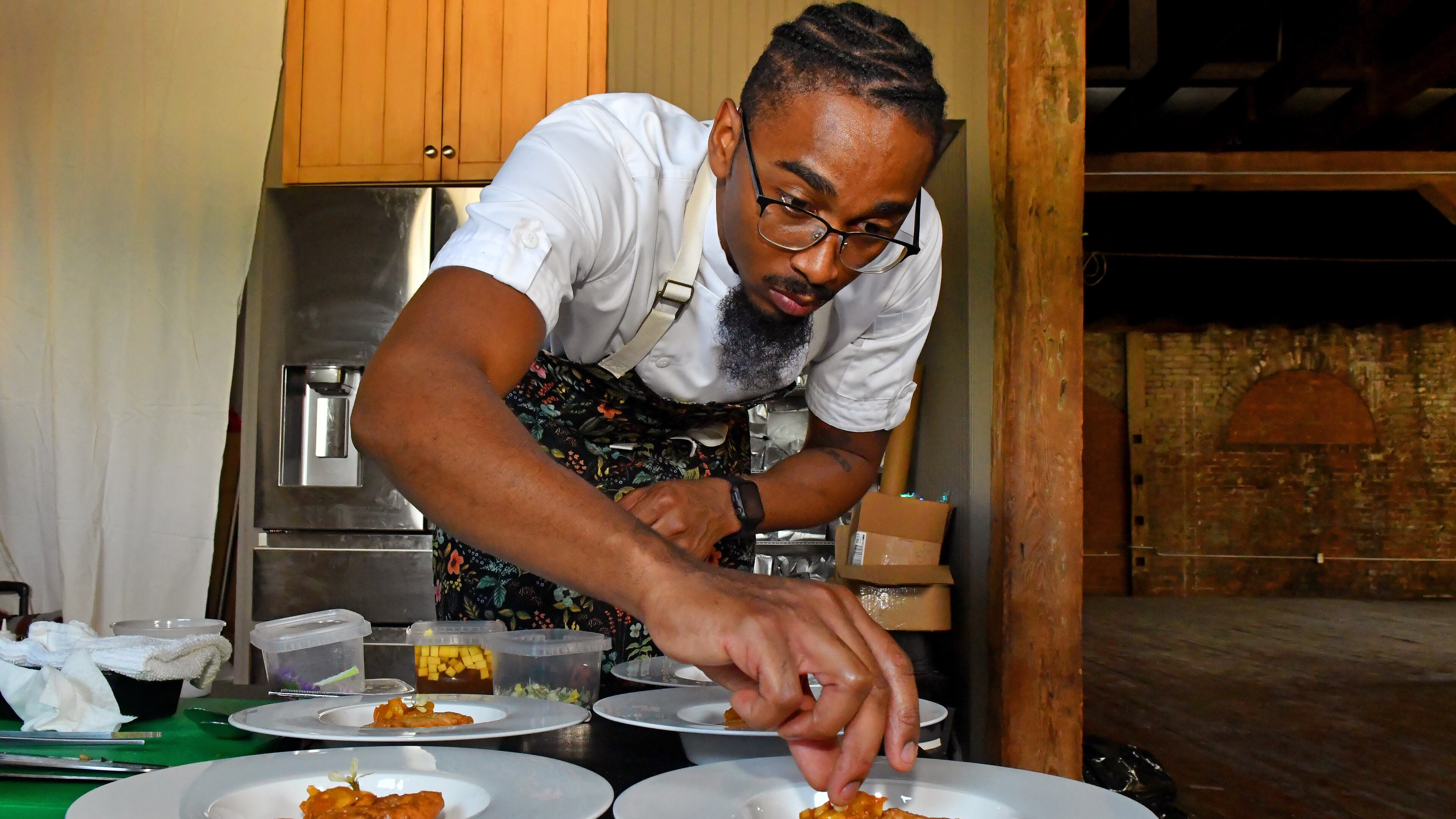 Chef Demetrius Brown prepared fried flatbread topped with marmalade as the sixth course of A Dinner at 29, an eight-course meal for the Heritage Supper Club designed to honor his Trinidadian great-grandmother, Elizabeth Castle. (CHRIS HUNT FOR THE ATLANTA JOURNAL-CONSTITUTION)