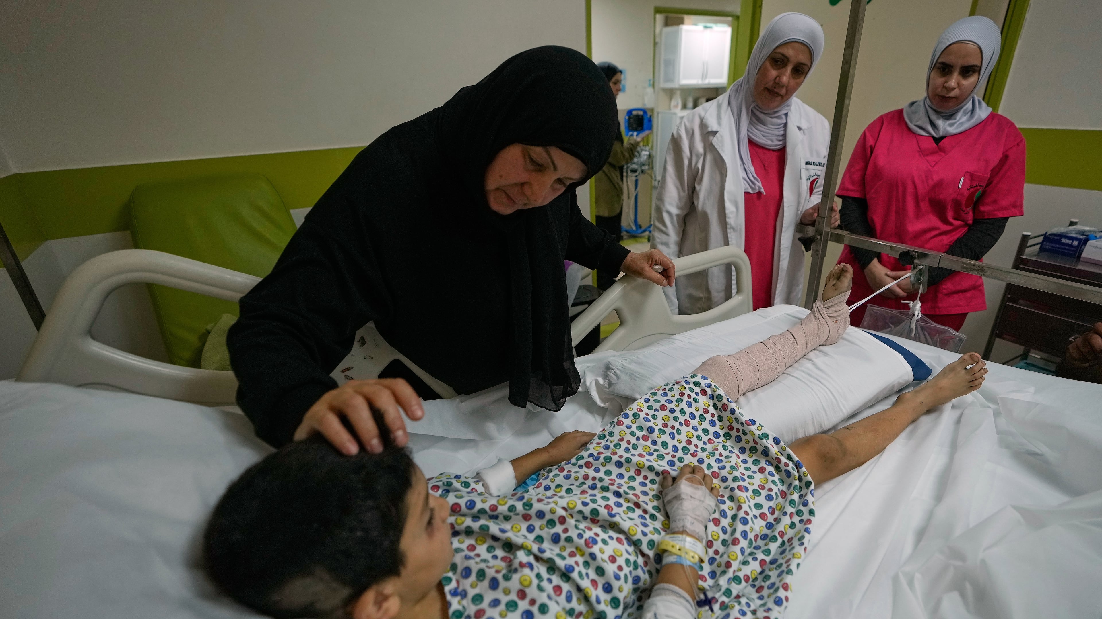 Mustafa Farhat, 8, who was injured in an Israeli airstrike that hit his home and killed his parents, is comforted by his grandmother at a hospital in the town of Nabatiyeh, southern Lebanon, Monday, Sept. 7, 2026. (AP Photo/Mohammed Zaatari)