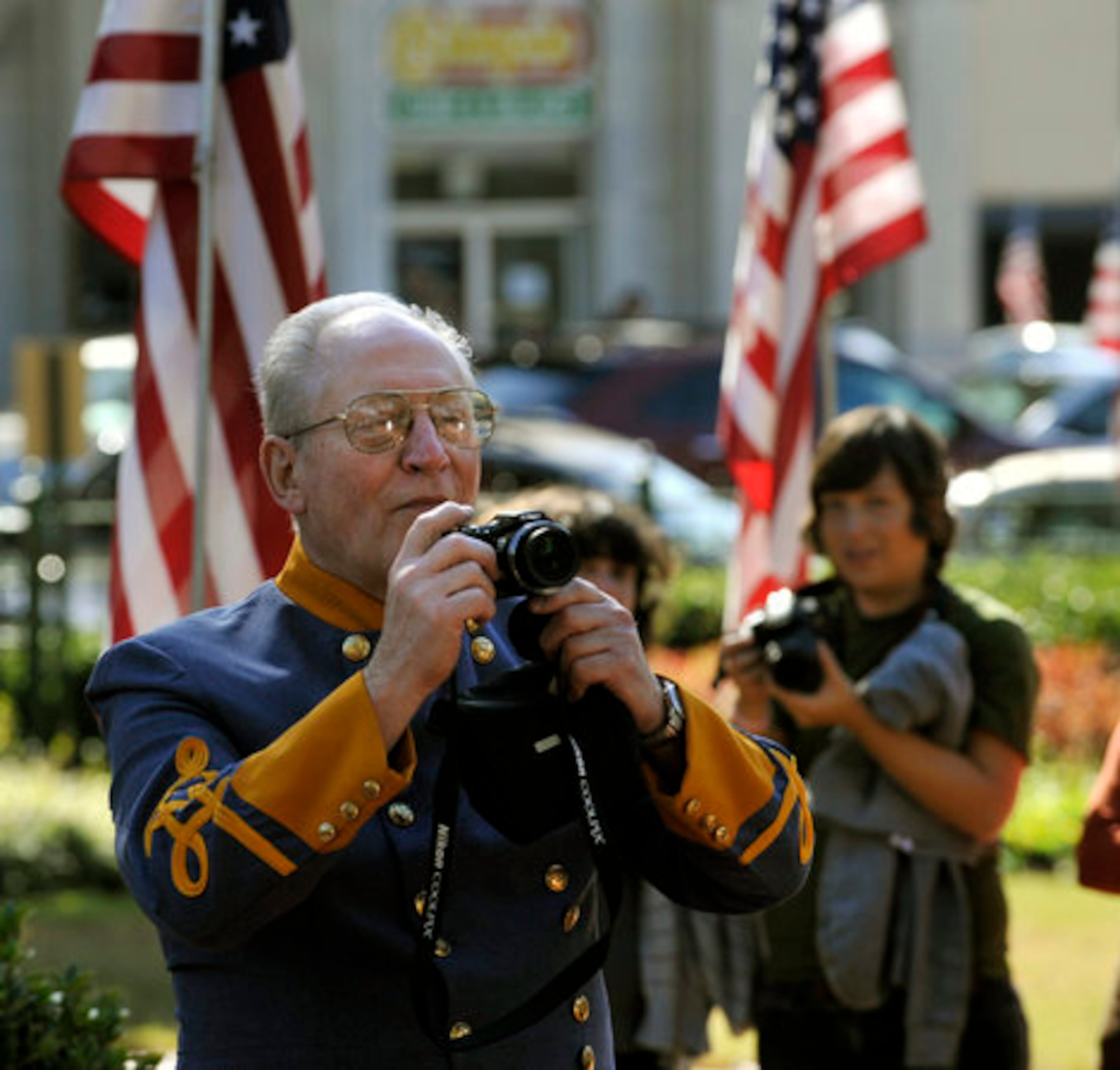 Richard Moskal, of Glen Ellyn, Illinois, takes a photograph of the dancers while in costume himself.
