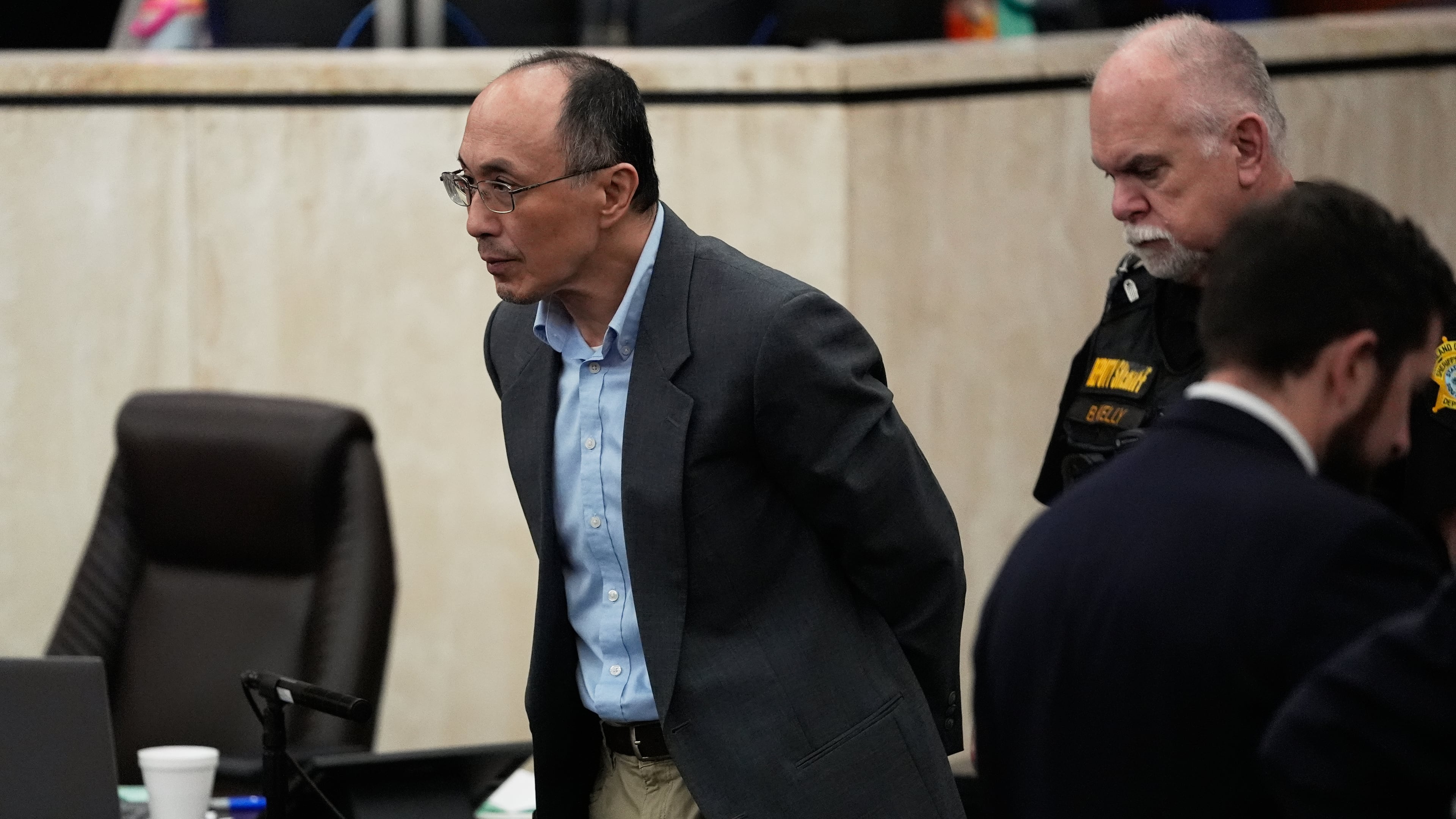 Chikei Rick Chow, left, accused in the 2023 fatal shooting of a Black 14-year-old, is escorted in the courtroom during his murder trial, Friday, May 29, 2026, in Columbia, S.C. (AP Photo/Erik Verduzco)